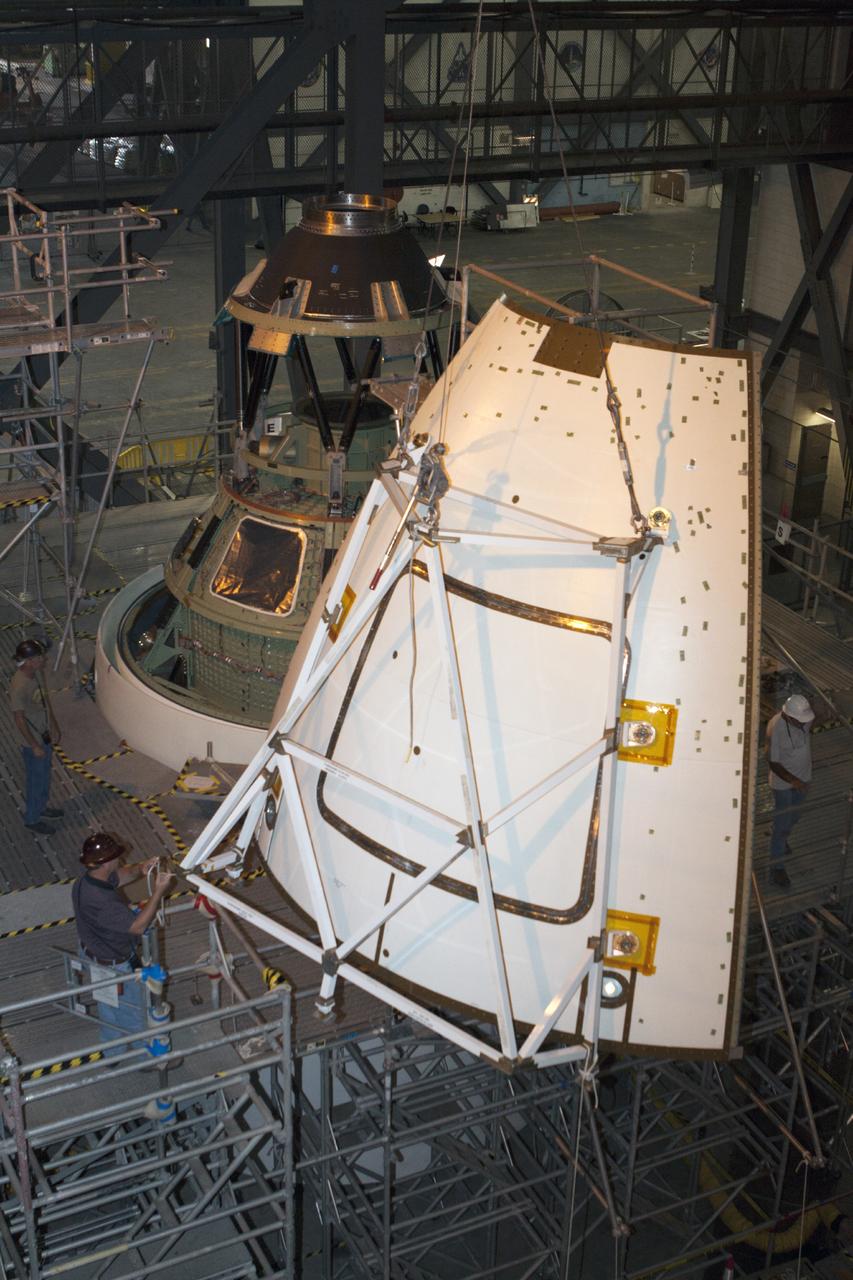 CAPE CANAVERAL, Fla. – At NASA’s Kennedy Space Center in Florida, technicians monitor the progress as a crane is used to move one of four ogive panels closer for installation on the Orion ground test vehicle in Vehicle Assembly Building high bay 4. The ogive panels enclose and protect the Orion spacecraft and attach to the Launch Abort System. The test vehicle is being used by the Ground Systems Development and Operations Program for path finding operations, including simulated manufacturing, assembly and stacking procedures. Orion is the exploration spacecraft designed to carry astronauts to destinations not yet explored by humans, including an asteroid and Mars. It will have emergency abort capability, sustain the crew during space travel and provide safe re-entry from deep space return velocities. The first unpiloted test flight of Orion is scheduled to launch in 2014 atop a Delta IV rocket and in 2017 on NASA’s Space Launch System rocket. For more information, visit www.nasa.gov/orion. Photo credit: Kim Shiflett