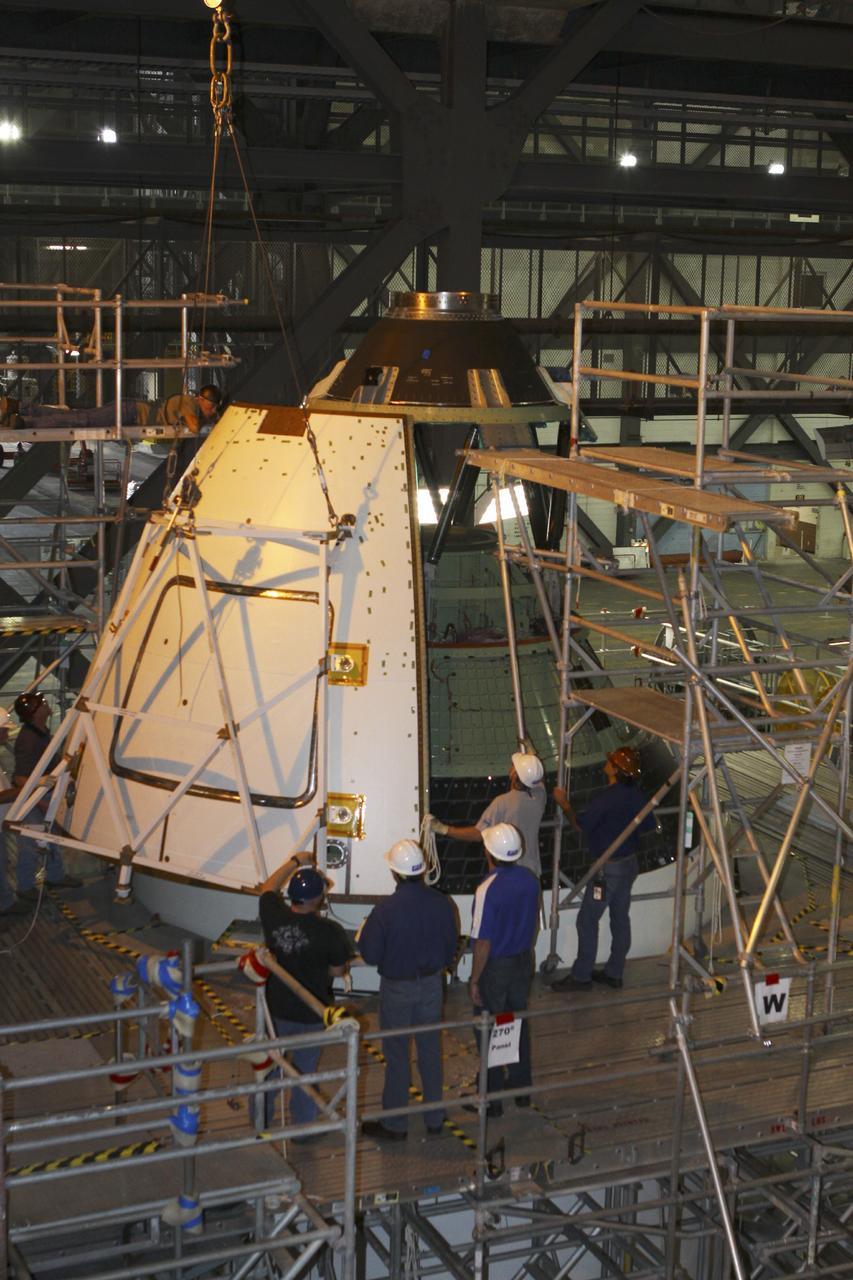 CAPE CANAVERAL, Fla. – At NASA’s Kennedy Space Center in Florida, technicians assist as a crane is used to move one of four ogive panels closer for installation on the Orion ground test vehicle in Vehicle Assembly Building high bay 4. The ogive panels enclose and protect the Orion spacecraft and attach to the Launch Abort System. The test vehicle is being used by the Ground Systems Development and Operations Program for path finding operations, including simulated manufacturing, assembly and stacking procedures. Orion is the exploration spacecraft designed to carry astronauts to destinations not yet explored by humans, including an asteroid and Mars. It will have emergency abort capability, sustain the crew during space travel and provide safe re-entry from deep space return velocities. The first unpiloted test flight of Orion is scheduled to launch in 2014 atop a Delta IV rocket and in 2017 on NASA’s Space Launch System rocket. For more information, visit www.nasa.gov/orion. Photo credit: Kim Shiflett