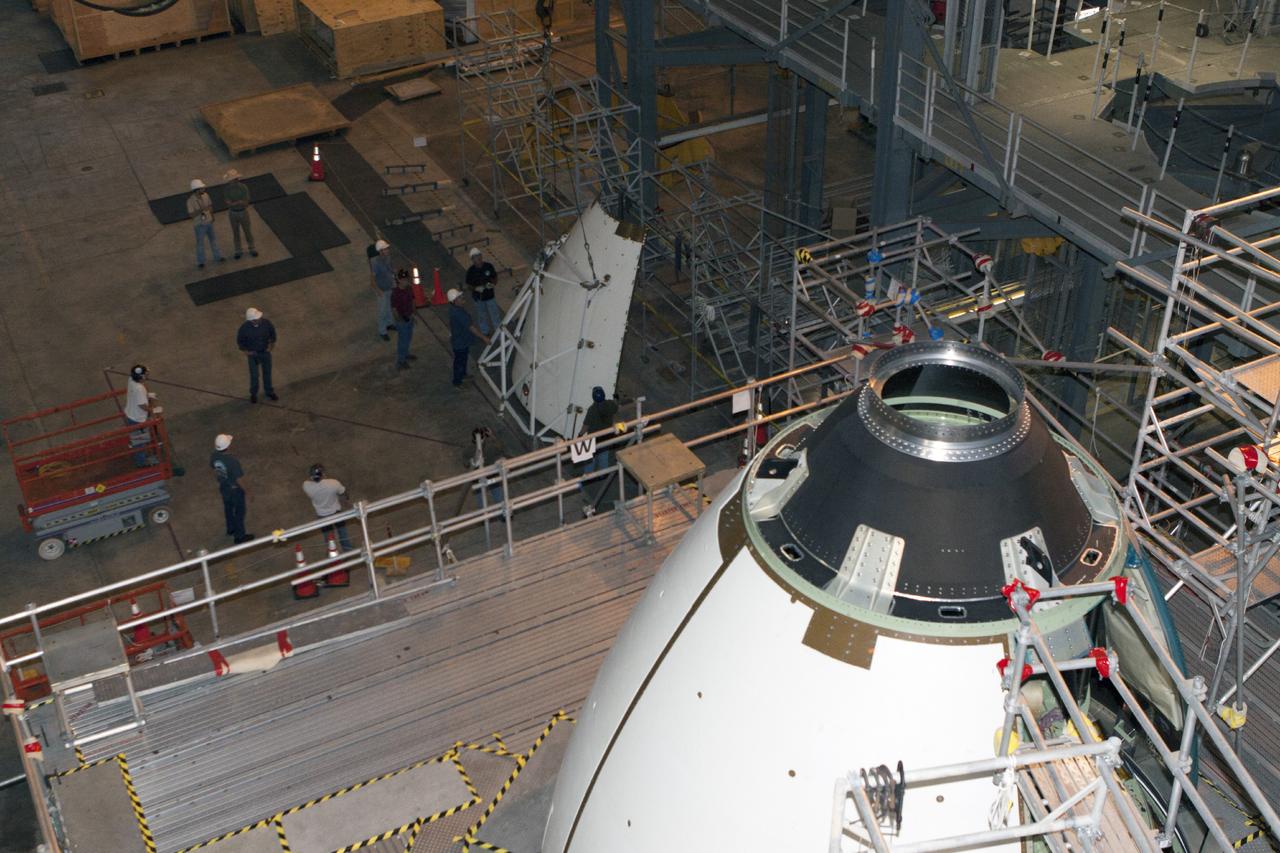 CAPE CANAVERAL, Fla. – At NASA’s Kennedy Space Center in Florida, three ogive panels have been installed on the Orion ground test vehicle in Vehicle Assembly Building high bay 4. The fourth ogive panel is being lifted by crane for installation. The ogive panels enclose and protect the Orion spacecraft and attach to the Launch Abort System. The test vehicle is being used by the Ground Systems Development and Operations Program for path finding operations, including simulated manufacturing, assembly and stacking procedures. Orion is the exploration spacecraft designed to carry astronauts to destinations not yet explored by humans, including an asteroid and Mars. It will have emergency abort capability, sustain the crew during space travel and provide safe re-entry from deep space return velocities. The first unpiloted test flight of Orion is scheduled to launch in 2014 atop a Delta IV rocket and in 2017 on NASA’s Space Launch System rocket. For more information, visit www.nasa.gov/orion. Photo credit: Kim Shiflett