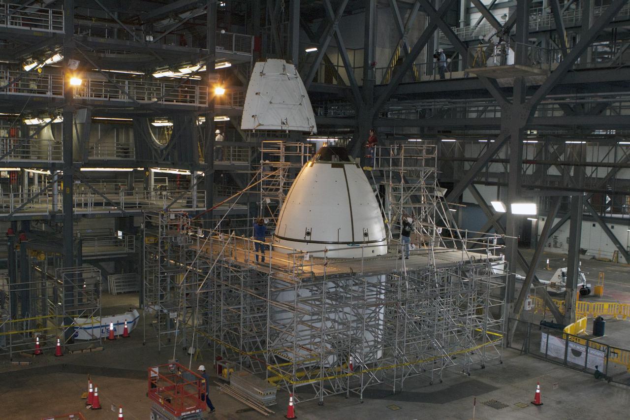 CAPE CANAVERAL, Fla. – At NASA’s Kennedy Space Center in Florida, technicians monitor the progress as the fourth ogive panel is lifted by crane so that they can be installed on the Orion ground test vehicle in Vehicle Assembly Building high bay 4. Three of the panels have already been installed on the test vehicle. The ogive panels enclose and protect the Orion spacecraft and attach to the Launch Abort System. The test vehicle is being used by the Ground Systems Development and Operations Program for path finding operations, including simulated manufacturing, assembly and stacking procedures. Orion is the exploration spacecraft designed to carry astronauts to destinations not yet explored by humans, including an asteroid and Mars. It will have emergency abort capability, sustain the crew during space travel and provide safe re-entry from deep space return velocities. The first unpiloted test flight of Orion is scheduled to launch in 2014 atop a Delta IV rocket and in 2017 on NASA’s Space Launch System rocket. For more information, visit www.nasa.gov/orion. Photo credit: Kim Shiflett