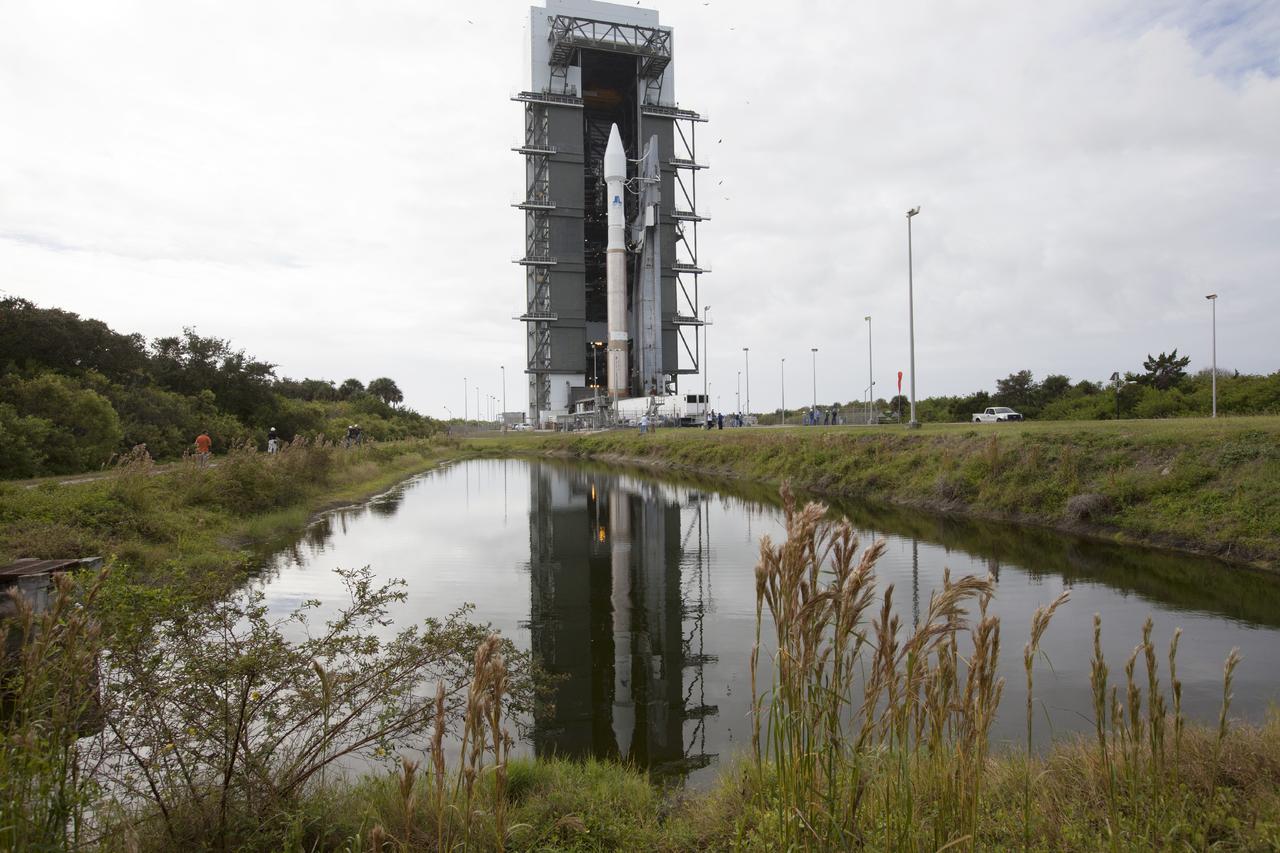 CAPE CANAVERAL, Fla. -- The United Launch Alliance Atlas V rocket carrying NASA’s Mars Atmosphere and Volatile EvolutioN, or MAVEN, spacecraft is reflected in the water beside the roadway as it rolls from the Vertical Integration Facility to Space Launch Complex 41 on Cape Canaveral Air Force Station in Florida. Rollout began on schedule with first motion at 9:57 a.m. Launch is scheduled for Nov. 18 during a window that extends from 1:28 to 3:28 p.m. Once positioned in orbit above the Red Planet, MAVEN will study its upper atmosphere in unprecedented detail. For more information, visit: http://www.nasa.gov/mission_pages/maven/main/index.html. Photo credit: NASA/Kim Shiflett