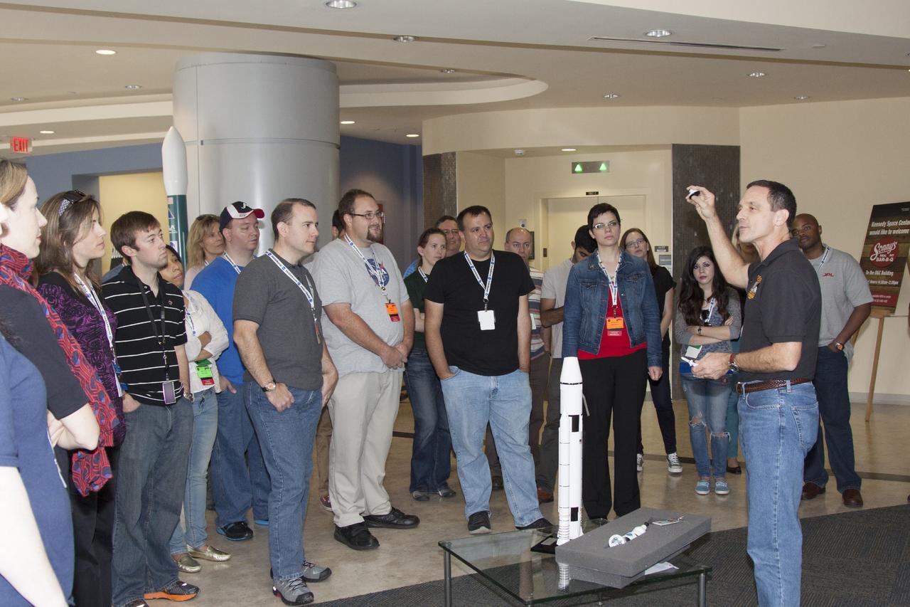 CAPE CANAVERAL, Fla. -- Social media participants are briefed on the Space Launch System rocket by Stu McClung, NASA's deputy manager of the Orion Production Office. They were on hand for the upcoming launch of the Mars Atmosphere and Volatile Evolution, or MAVEN, mission.      Their visit included tours of key facilities at the Florida Spaceport and participating in presentations by key NASA leaders who updated the space agency's current efforts. Photo credit: NASA/Jim Grossman
