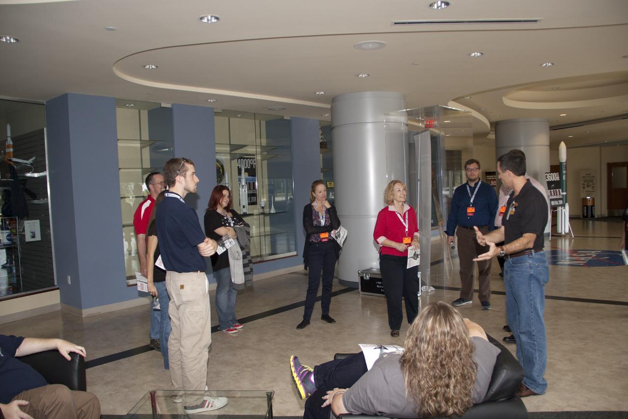 CAPE CANAVERAL, Fla. -- Social media participants are briefed on the Space Launch System rocket by Stu McClung, NASA's deputy manager of the Orion Production Office. They were on hand for the upcoming launch of the Mars Atmosphere and Volatile Evolution, or MAVEN, mission.      Their visit included tours of key facilities at the Florida Spaceport and participating in presentations by key NASA leaders who updated the space agency's current efforts. Photo credit: NASA/Jim Grossman