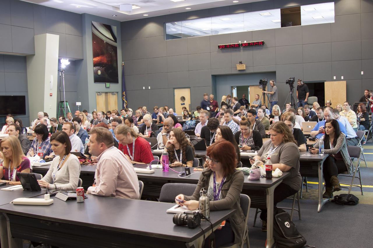 CAPE CANAVERAL, Fla. -- In the conference room of Operations Support Building II at NASA's Kennedy Space Center in Florida, social media participants listen to a briefing on the Mars Atmosphere and Volatile Evolution, or MAVEN, mission.      The social media participants gathered at the Florida spaceport for the launch of the Mars Atmosphere and Volatile Evolution, or MAVEN, spacecraft. Their visit included tours of key facilities and participating in presentations by key NASA leaders who updated the space agency's current efforts. Photo credit: NASA/Jim Grossman