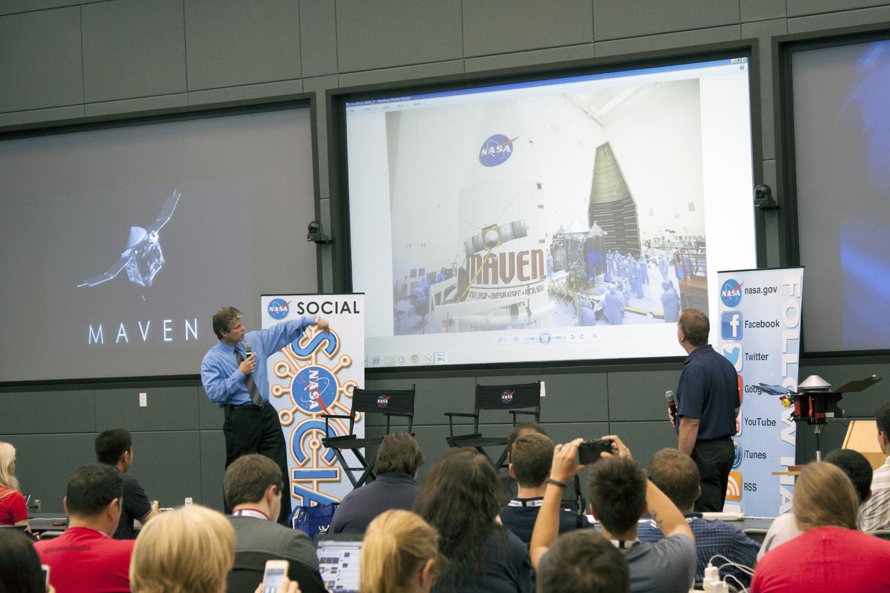 CAPE CANAVERAL, Fla. -- In the conference room of Operations Support Building II at NASA's Kennedy Space Center in Florida, social media participants listen to a briefing on the Mars Atmosphere and Volatile Evolution, or MAVEN, mission by, Joseph Fust, an engineer with United Launch Alliance, left, and Michael Wolfman, agency Vehicle System engineer.         The social media participants gathered at the Florida spaceport for the launch of the Mars Atmosphere and Volatile Evolution, or MAVEN, spacecraft. Their visit included tours of key facilities and participating in presentations by key NASA leaders who updated the space agency's current efforts. Photo credit: NASA/Jim Grossman