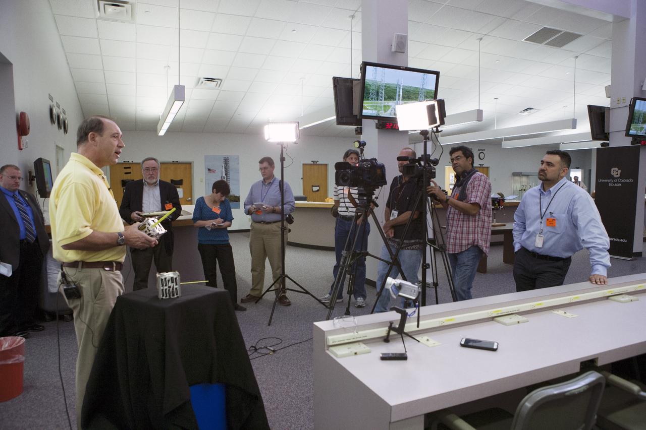 CAPE CANAVERAL, Fla. -- At the News Center at NASA's Kennedy Space Center in Florida, Andrew Petro, the agency's acting director of the Early Stage Innovation Division of the Office of the Chief Technologist, discusses the agency’s CubeSat Launch initiative. CubeSats provide opportunities for small satellite payloads to fly on rockets planned for upcoming launches.      CubeSats, a class of research spacecraft called nanosatellites, are flown as auxiliary payloads on previously planned missions. The cube-shaped satellites are approximately four inches long, have a volume of about one quart and weigh about three pounds. For more information, visit: http://www.nasa.gov/directorates/heo/home/CubeSats_initiative.html Photo credit: NASA/Kim Shiflett