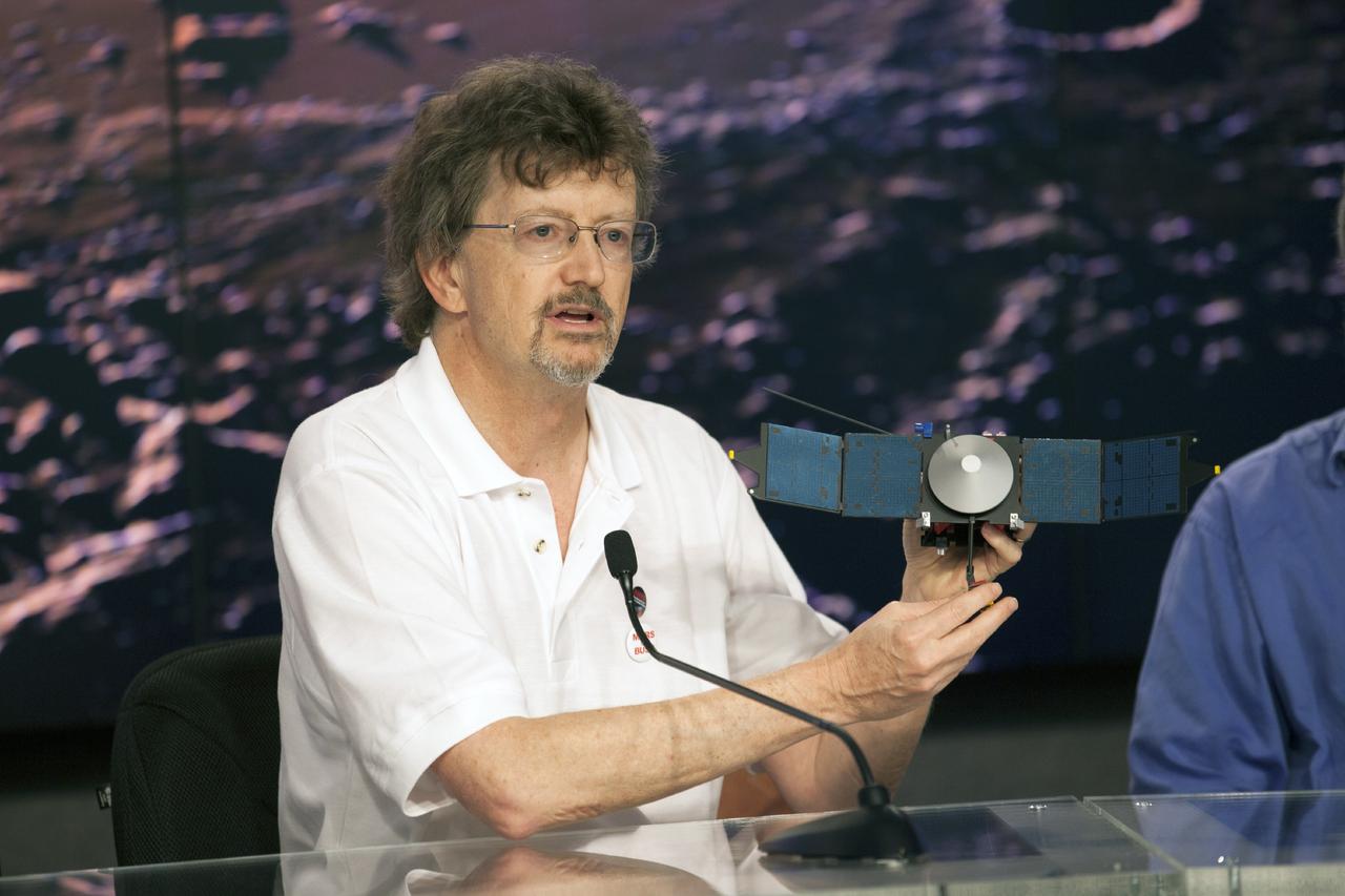 CAPE CANAVERAL, Fla. – During a news conference at NASA's Kennedy Space Center in Florida, NASA officials and university investigators outlined science plans for the Mars Atmosphere and Volatile EvolutioN, or MAVEN, mission. Briefing participants included Nick Schneider, holding a model of the MAVEN spacecraft. He is the Imaging Ultraviolet Spectrograph, or IUVS, instrument lead at the Laboratory for Atmospheric and Space Physics at the University of Colorado at Boulder. MAVEN is being prepared for its scheduled launch on Nov 18, 2013 from Cape Canaveral Air Force Station, Fla. atop a United Launch Alliance Atlas V rocket. Positioned in an orbit above the Red Planet, MAVEN will study the upper atmosphere of Mars in unprecedented detail. For information on the MAVEN mission, visit: http://www.nasa.gov/mission_pages/maven/main/index.html. Photo credit: NASA/Kim Shiflett