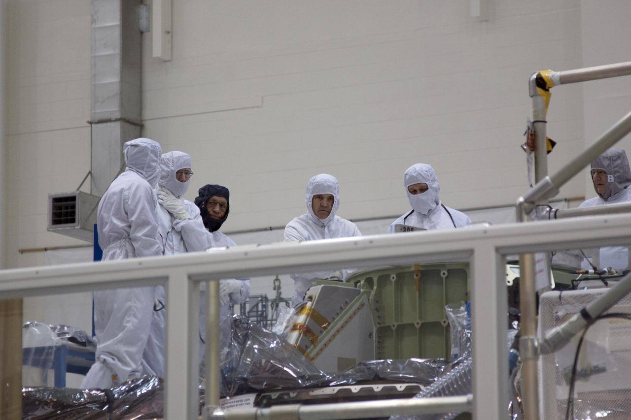 CAPE CANAVERAL, Fla. – Inside the Operations and Checkout Building high bay at NASA’s Kennedy Space Center in Florida, agency Administrator Charles Bolden, third from the left, and center Director Bob Cabana, fourth from the left, inspect the Orion spacecraft crew module for its first unpiloted launch, Exploration Test Flight 1.      Orion is the exploration spacecraft designed to carry crews to space beyond low Earth orbit. It will provide emergency abort capability, sustain the crew during the space travel and provide safe re-entry from deep space return velocities. Orion’s first unpiloted test launch is scheduled for liftoff during 2014 atop a Delta IV rocket. A second unpiloted flight test is scheduled for 2017 on NASA’s Space Launch System rocket. For more information, visit http://www.nasa.gov/orion Photo credit: NASA/Jim Grossman