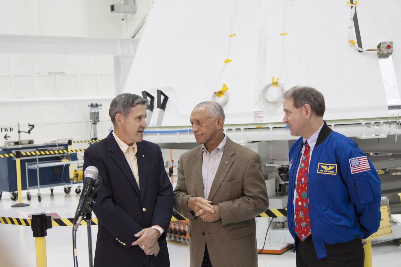 CAPE CANAVERAL, Fla. – Inside the Operations and Checkout Building high bay at NASA’s Kennedy Space Center in Florida, center Director Bob Cabana, left, and agency Administrator Charles Bolden, center, discuss preparations of the Orion spacecraft with John Grunsfeld, NASA associate administrator for the Science Mission Directorate.      Orion is the exploration spacecraft designed to carry crews to space beyond low Earth orbit. It will provide emergency abort capability, sustain the crew during the space travel and provide safe re-entry from deep space return velocities. Orion’s first unpiloted test launch is scheduled for liftoff during 2014 atop a Delta IV rocket. A second unpiloted flight test is scheduled for 2017 on NASA’s Space Launch System rocket. For more information, visit http://www.nasa.gov/orion Photo credit: NASA/Jim Grossman