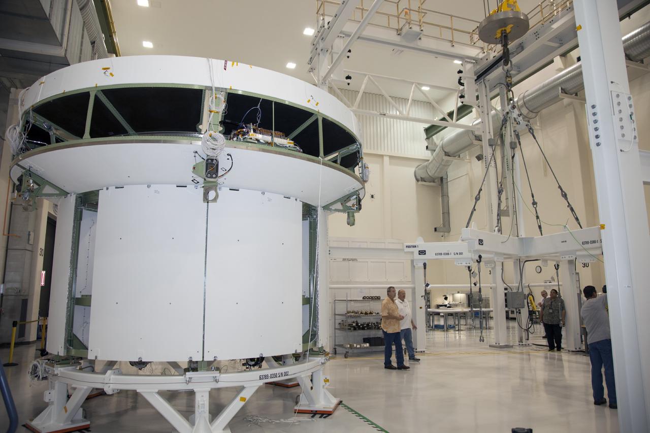 CAPE CANAVERAL, Fla. -- Inside the Operations and Checkout Building high bay at NASA’s Kennedy Space Center in Florida, technicians are preparing a crane to lift the service module bulkhead for the Orion spacecraft. The service module will be mated to the spacecraft adapter cone for testing. Technicians have applied shims, drilled fasteners and built up the cable harnesses on the bulkhead.    Orion is the exploration spacecraft designed to carry astronauts to destinations not yet explored by humans, including an asteroid and Mars. It will have emergency abort capability, sustain the crew during space travel and provide safe re-entry from deep space return velocities. The first unpiloted test flight of the Orion is scheduled to launch in 2014 atop a Delta IV rocket and in 2017 on NASA’s Space Launch System rocket. For more information, visit http://www.nasa.gov/orion. Photo credit: NASA/Daniel Casper