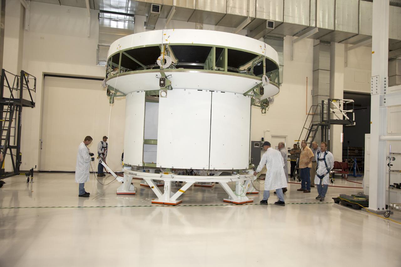 CAPE CANAVERAL, Fla. -- Inside the Operations and Checkout Building high bay at NASA’s Kennedy Space Center in Florida, technicians prepare the service module bulkhead for the Orion spacecraft for the move to a lifting station. The service module will be mated to the spacecraft adapter cone for testing.    Orion is the exploration spacecraft designed to carry astronauts to destinations not yet explored by humans, including an asteroid and Mars. It will have emergency abort capability, sustain the crew during space travel and provide safe re-entry from deep space return velocities. The first unpiloted test flight of the Orion is scheduled to launch in 2014 atop a Delta IV rocket and in 2017 on NASA’s Space Launch System rocket. For more information, visit http://www.nasa.gov/orion. Photo credit: NASA/Daniel Casper