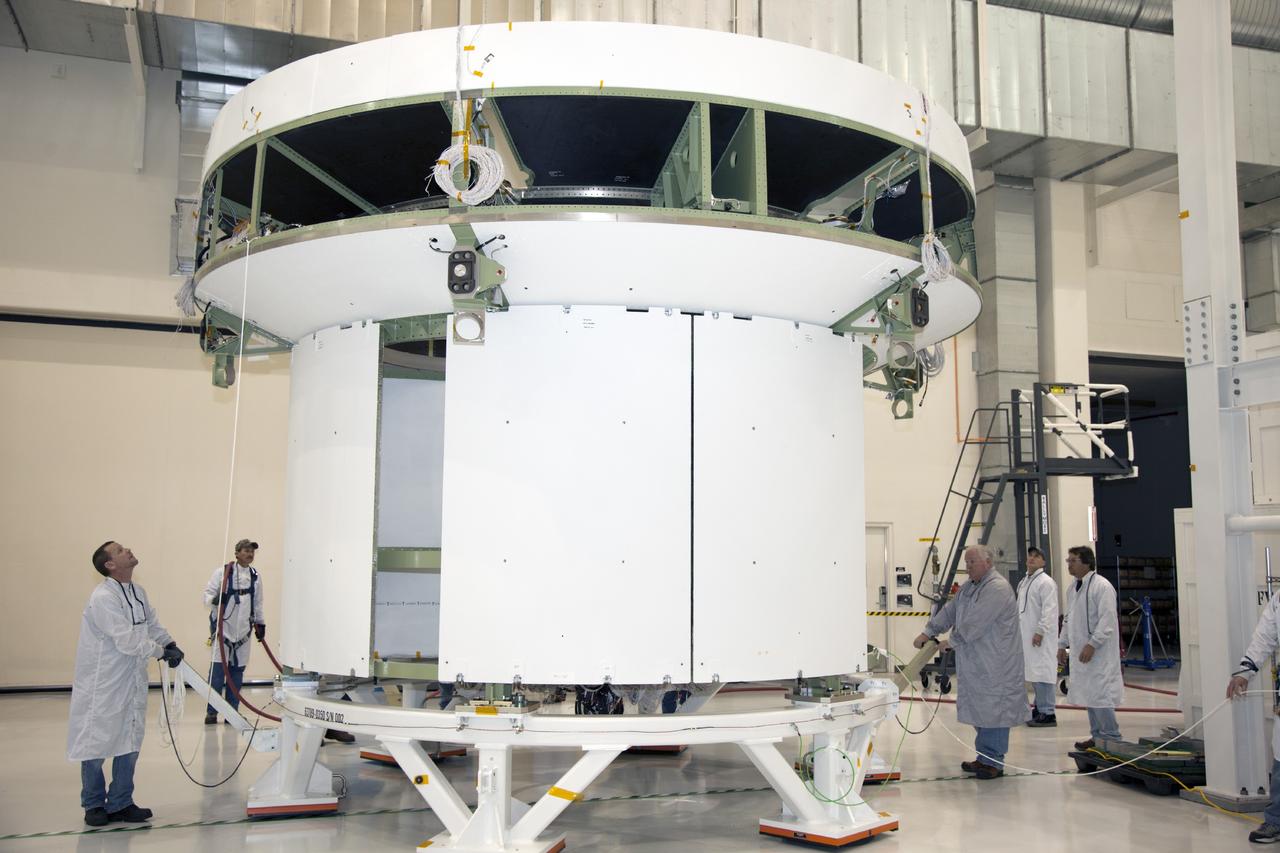 CAPE CANAVERAL, Fla. -- Inside the Operations and Checkout Building high bay at NASA’s Kennedy Space Center in Florida, technicians prepare the service module bulkhead for the Orion spacecraft for the move to a lifting station. The service module will be mated to the spacecraft adapter cone for testing. Orion is the exploration spacecraft designed to carry astronauts to destinations not yet explored by humans, including an asteroid and Mars. It will have emergency abort capability, sustain the crew during space travel and provide safe re-entry from deep space return velocities. The first unpiloted test flight of the Orion is scheduled to launch in 2014 atop a Delta IV rocket and in 2017 on NASA’s Space Launch System rocket. For more information, visit http://www.nasa.gov/orion. Photo credit: NASA/Daniel Casper