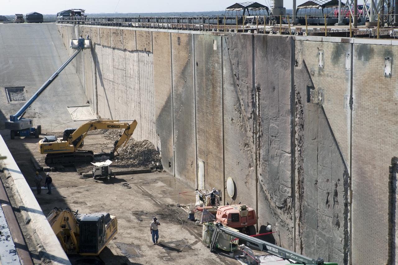 CAPE CANAVERAL, Fla. -- At Launch Pad 39B at NASA’s Kennedy Space Center in Florida, construction workers continue to remove the bricks from the flame trench walls that are below and between the left and right crawlerway tracks. New crawler track panels will be installed. The space shuttle-era flame trench deflector has been completely removed.    Launch Pad 39B is being refurbished to support NASA’s Space Launch System and other launch vehicles. The Ground Systems Development and Operations, or GSDO, Program office at Kennedy is leading the center’s transformation to safely handle a variety of rockets and spacecraft. For more information about GSDO, visit: http://go.nasa.gov/groundsystems.  Photo credit: NASA/Kim Shiflett