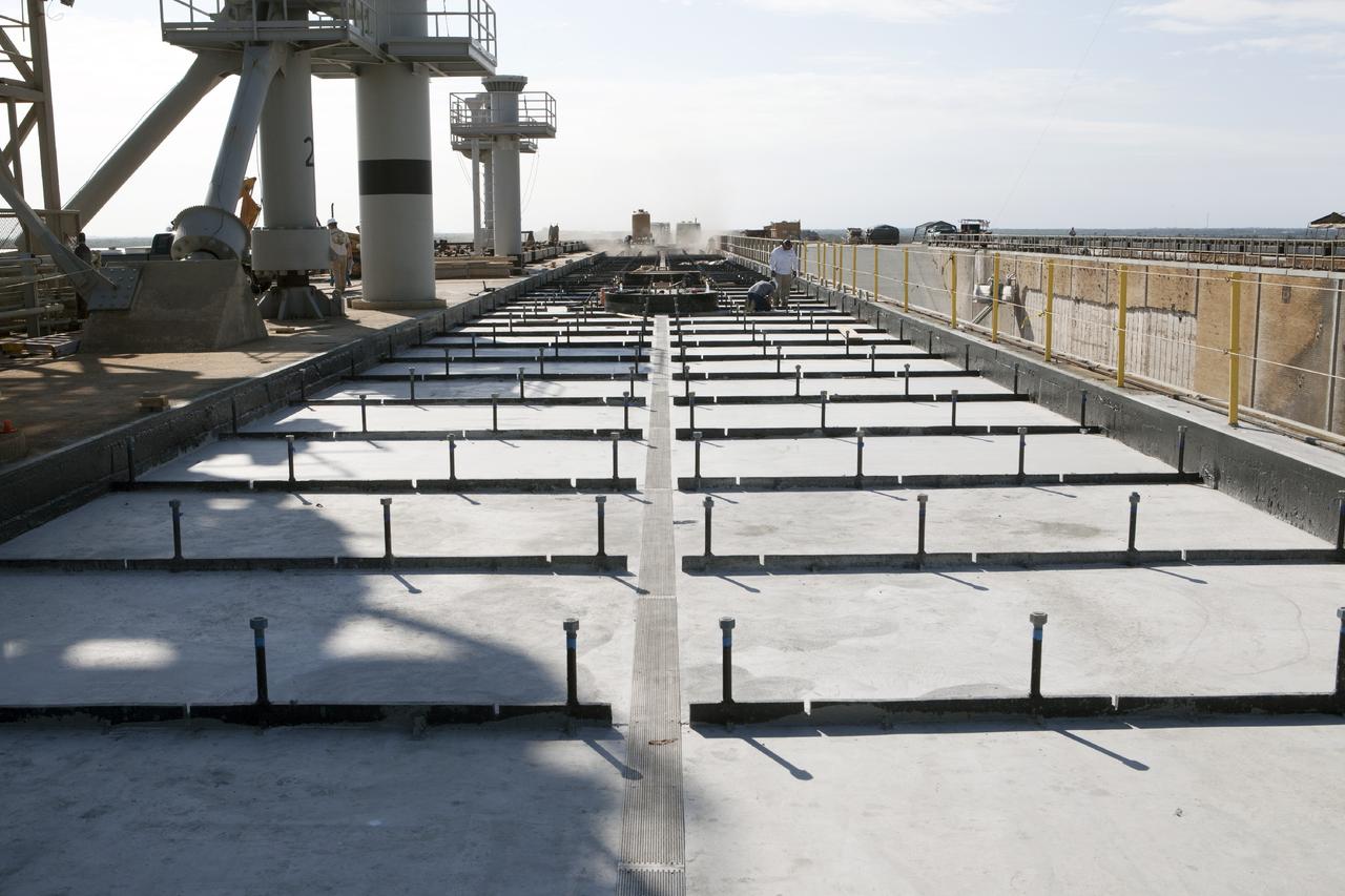 CAPE CANAVERAL, Fla. -- At Launch Pad 39B at NASA’s Kennedy Space Center in Florida, all of the old crawler track panels have been removed from the surface and construction workers are repairing the concrete surface and catacomb roof below. New crawler track panels will be installed.     Launch Pad 39B is being refurbished to support NASA’s Space Launch System and other launch vehicles. The Ground Systems Development and Operations, or GSDO, Program office at Kennedy is leading the center’s transformation to safely handle a variety of rockets and spacecraft. For more information about GSDO, visit: http://go.nasa.gov/groundsystems.  Photo credit: NASA/Kim Shiflett