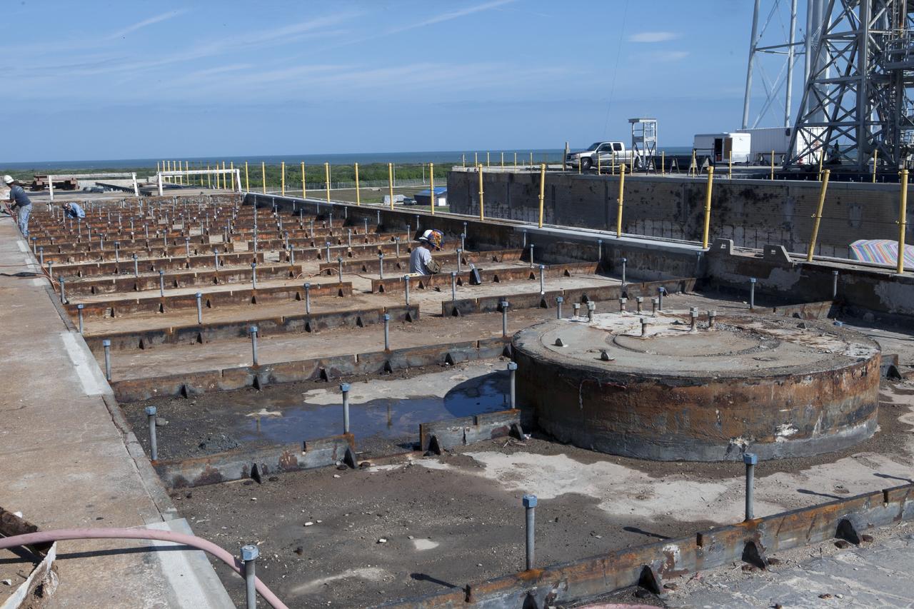 CAPE CANAVERAL, Fla. -- At Launch Pad 39B at NASA’s Kennedy Space Center in Florida, all of the old crawler track panels have been removed from the surface and construction workers are repairing the concrete surface and catacomb roof below. New crawler track panels will be installed.      Launch Pad 39B is being refurbished to support NASA’s Space Launch System and other launch vehicles. The Ground Systems Development and Operations, or GSDO, Program office at Kennedy is leading the center’s transformation to safely handle a variety of rockets and spacecraft. For more information about GSDO, visit: http://go.nasa.gov/groundsystems.  Photo credit: NASA/Kim Shiflett