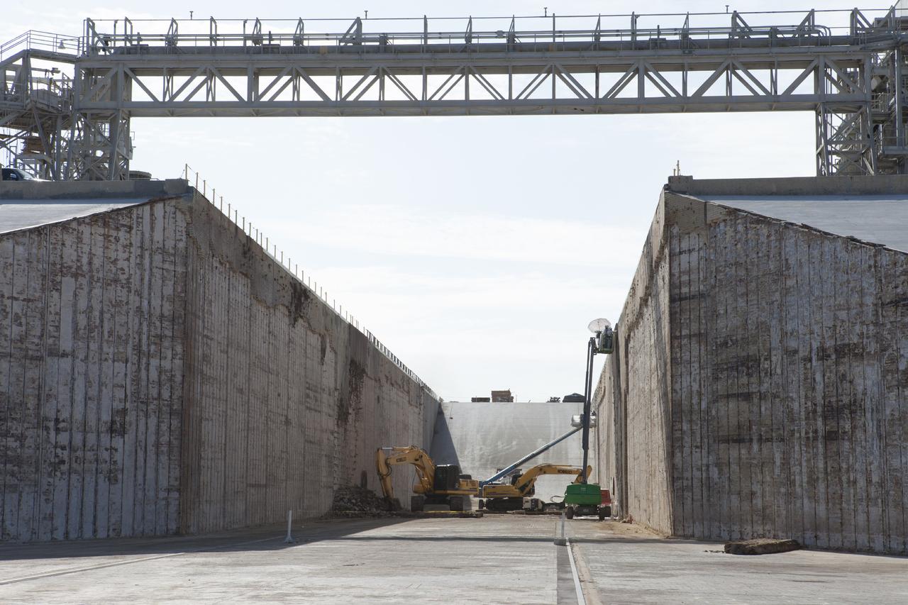 CAPE CANAVERAL, Fla. -- At Launch Pad 39B at NASA’s Kennedy Space Center in Florida, construction workers continue to remove the bricks from the flame trench walls that are below and between the left and right crawlerway tracks. The space shuttle-era flame trench deflector has been completely removed.      Launch Pad 39B is being refurbished to support NASA’s Space Launch System and other launch vehicles. The Ground Systems Development and Operations, or GSDO, Program office at Kennedy is leading the center’s transformation to safely handle a variety of rockets and spacecraft. For more information about GSDO, visit: http://go.nasa.gov/groundsystems.  Photo credit: NASA/Kim Shiflett