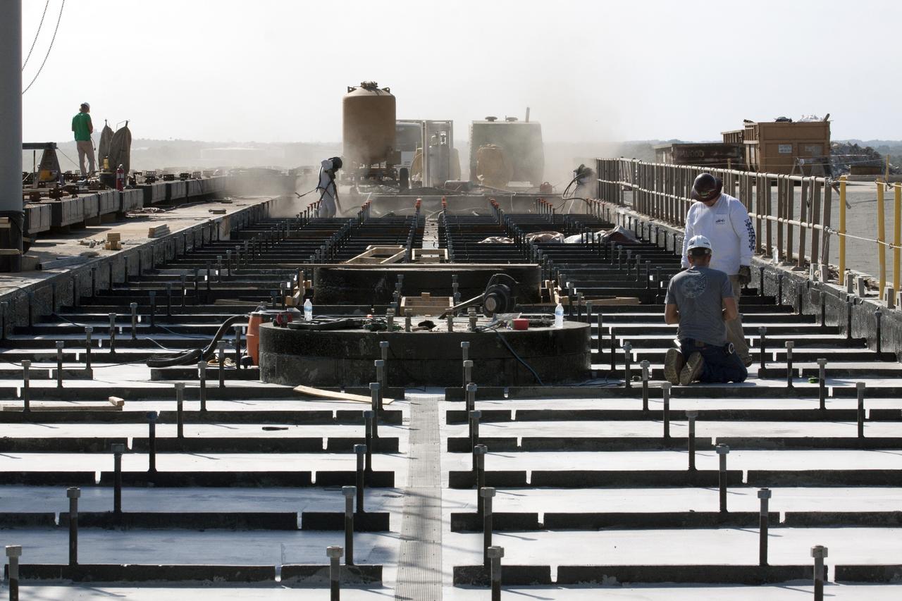 CAPE CANAVERAL, Fla. -- At Launch Pad 39B at NASA’s Kennedy Space Center in Florida, all of the old crawler track panels have been removed from the surface and construction workers are repairing the concrete surface and catacomb roof below. Framing for the new crawler track panels is being installed in repaired areas of the pad surface.    Launch Pad 39B is being refurbished to support NASA’s Space Launch System and other launch vehicles. The Ground Systems Development and Operations, or GSDO, Program office at Kennedy is leading the center’s transformation to safely handle a variety of rockets and spacecraft. For more information about GSDO, visit: http://go.nasa.gov/groundsystems.  Photo credit: NASA/Kim Shiflett