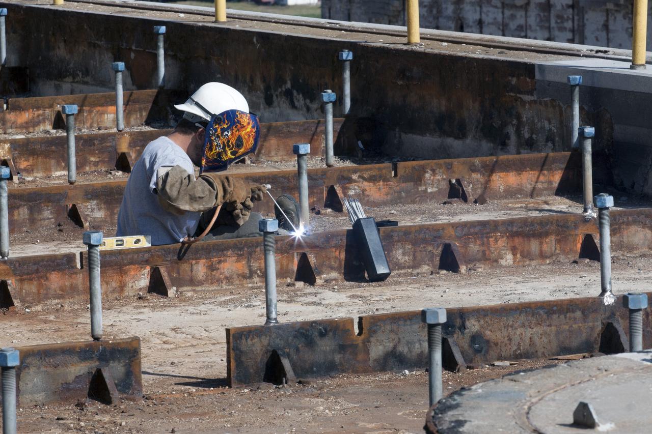 CAPE CANAVERAL, Fla. -- At Launch Pad 39B at NASA’s Kennedy Space Center in Florida, all of the old crawler track panels have been removed from the surface and construction workers are repairing the concrete surface and catacomb roof below. Framing for the new crawler track panels is being installed in repaired areas of the pad surface.    Launch Pad 39B is being refurbished to support NASA’s Space Launch System and other launch vehicles. The Ground Systems Development and Operations, or GSDO, Program office at Kennedy is leading the center’s transformation to safely handle a variety of rockets and spacecraft. For more information about GSDO, visit: http://go.nasa.gov/groundsystems.  Photo credit: NASA/Kim Shiflett