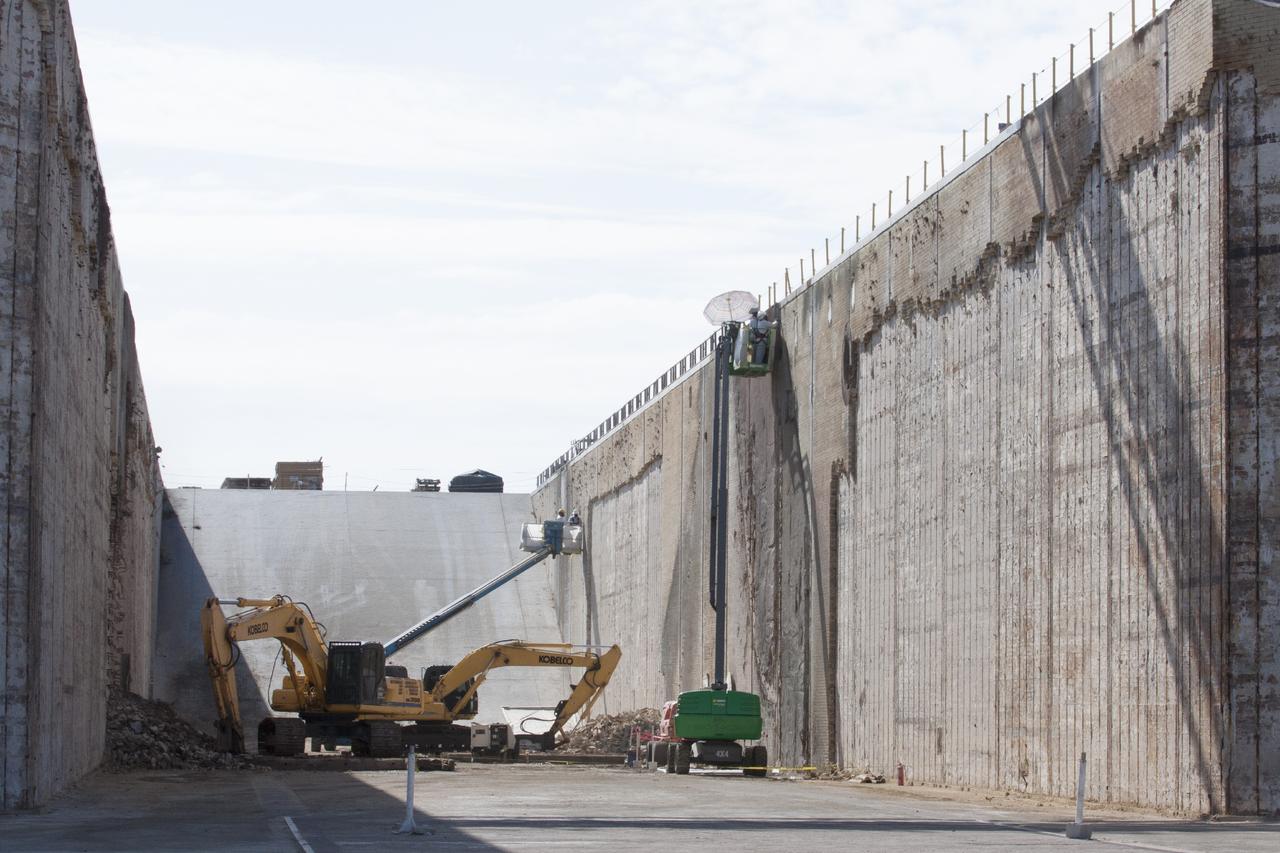 CAPE CANAVERAL, Fla. -- At Launch Pad 39B at NASA’s Kennedy Space Center in Florida, construction workers continue to remove the bricks from the flame trench walls that are below and between the left and right crawlerway tracks. The space shuttle-era flame trench deflector has been completely removed.    Launch Pad 39B is being refurbished to support NASA’s Space Launch System and other launch vehicles. The Ground Systems Development and Operations, or GSDO, Program office at Kennedy is leading the center’s transformation to safely handle a variety of rockets and spacecraft. For more information about GSDO, visit: http://go.nasa.gov/groundsystems.  Photo credit: NASA/Kim Shiflett