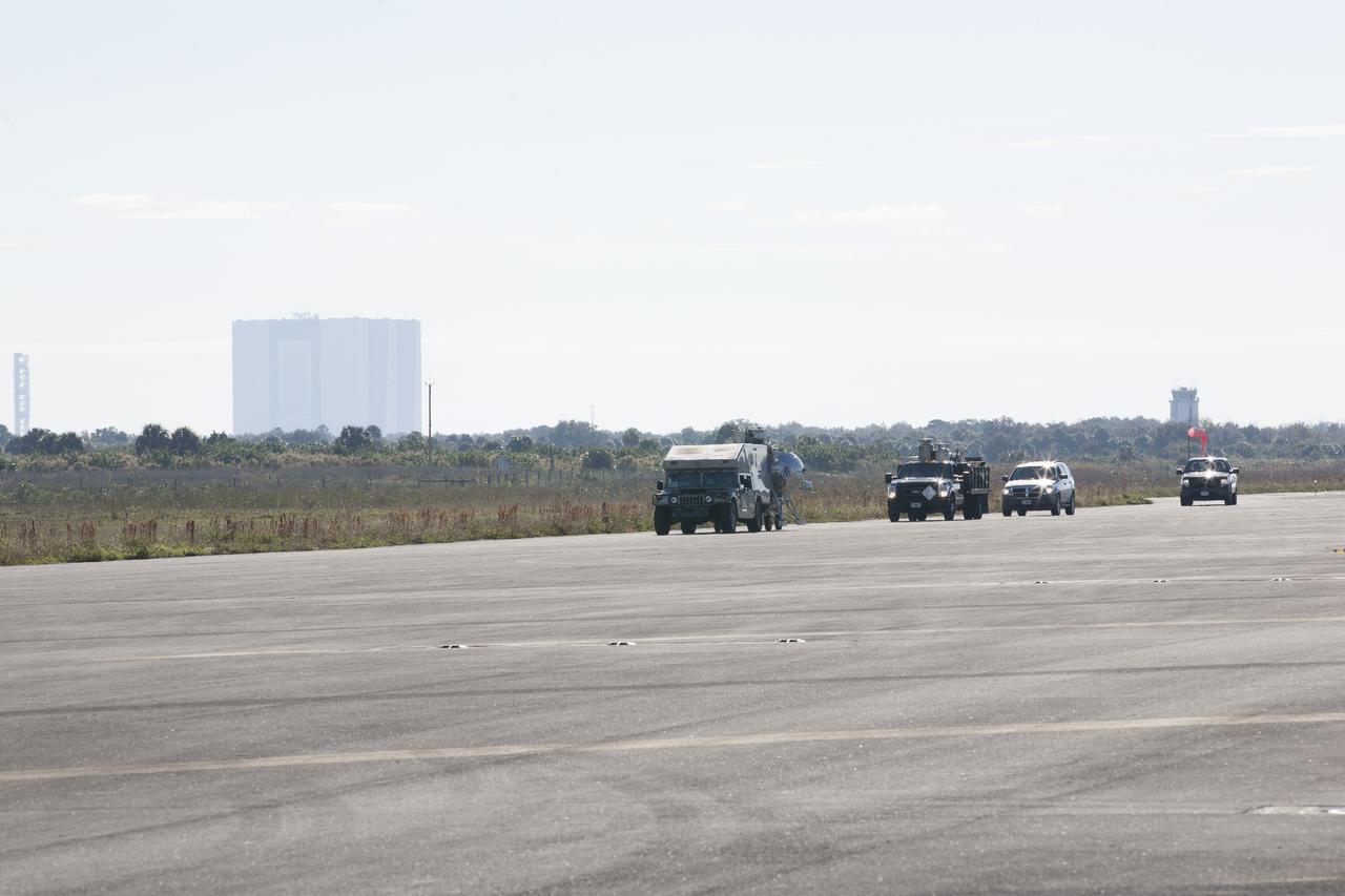 CAPE CANAVERAL, Fla. -- At NASA’s Kennedy Space Center in Florida, a convoy of vehicles accompanies the Project Morpheus prototype lander as it is transported to a launch platform at the north end of the Shuttle Landing Facility. Testing of the prototype lander has been ongoing at NASA’s Johnson Space Center in Houston in preparation for tethered and free flight testing at Kennedy. The landing facility will provide the lander with the kind of field necessary for realistic testing, complete with rocks, craters and hazards to avoid. Morpheus utilizes an autonomous landing and hazard avoidance technology, or ALHAT, payload that will allow it to navigate to clear landing sites amidst rocks, craters and other hazards during its descent. Project Morpheus is being managed under the Advanced Exploration Systems, or AES, Division in NASA’s Human Exploration and Operations Mission Directorate. The efforts in AES pioneer new approaches for rapidly developing prototype systems, demonstrating key capabilities and validating operational concepts for future human missions beyond Earth orbit. For more information on Project Morpheus, visit http://morpheuslander.jsc.nasa.gov. Photo credit: NASA/Kim Shiflett