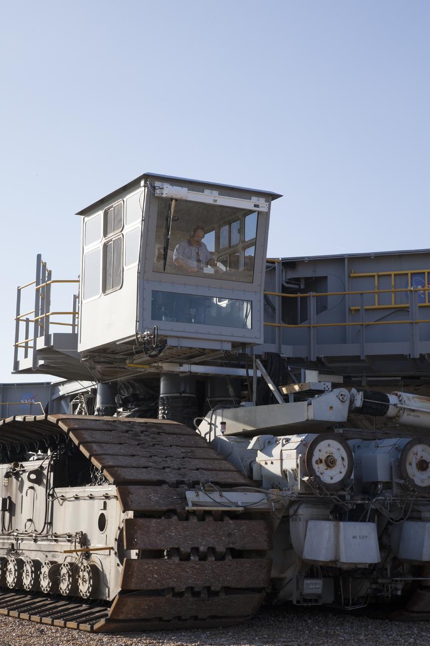CAPE CANAVERAL, Fla. -- A driver works the controls inside the cab on crawler-transporter 1 as it makes the trek to Launch Pad 39A at NASA’s Kennedy Space Center in Florida. New jacking, equalizing and leveling, or JEL, hydraulic cylinders were installed on CT-1. They are being tested for increased load carrying capacity and reliability. The Ground Systems Development and Operations Program at Kennedy continues to upgrade the crawler-transporter as part of its general maintenance. CT-1 could be available to carry a variety of launch vehicles to the launch pad. Two crawler-transporters were used to carry the mobile launcher platform and space shuttle to Launch Complex 39 for space shuttle launches for 30 years. Photo credit: NASA/Daniel Casper