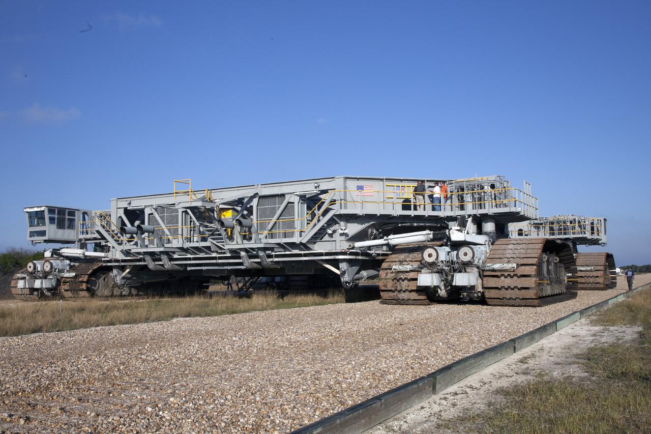 CAPE CANAVERAL, Fla. -- Ground support equipment technicians monitor the progress as crawler-transporter 1 continues its trek along the crawlerway to Launch Pad 39A at NASA’s Kennedy Space Center in Florida. New jacking, equalizing and leveling, or JEL, hydraulic cylinders were installed on CT-1 and are being tested for increased load carrying capacity and reliability. The Ground Systems Development and Operations Program at Kennedy continues to upgrade the crawler-transporter as part of its general maintenance. CT-1 could be available to carry a variety of launch vehicles to the launch pad. Two crawler-transporters were used to carry the mobile launcher platform and space shuttle to Launch Complex 39 for space shuttle launches for 30 years. Photo credit: NASA/Daniel Casper