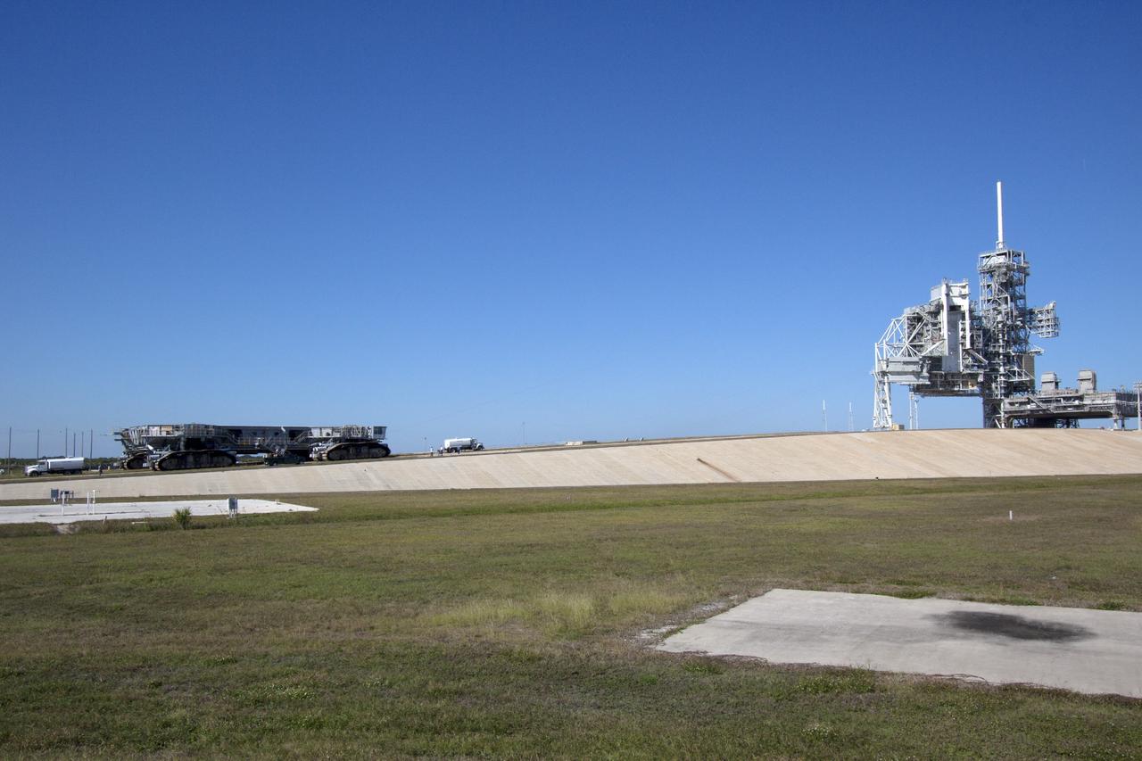CAPE CANAVERAL, Fla. -- Crawler-transporter 1 continues its trek up the slope on the crawlerway leading up to Launch Pad 39A at NASA’s Kennedy Space Center in Florida. New jacking, equalizing and leveling, or JEL, hydraulic cylinders were installed on CT-1 and are undergoing a leveling and turning test as the crawler travels along the slope to the top of the pad. The Ground Systems Development and Operations Program at Kennedy continues to upgrade the crawler-transporter as part of its general maintenance. CT-1 could be available to carry a variety of launch vehicles to the launch pad. Two crawler-transporters were used to carry the mobile launcher platform and space shuttle to Launch Complex 39 for space shuttle launches for 30 years. Photo credit: NASA/Jim Grossmann