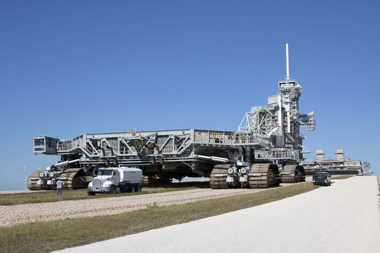 CAPE CANAVERAL, Fla. -- Crawler-transporter 1 approaches the top of Launch Pad 39A after traveling along the crawlerway at NASA’s Kennedy Space Center in Florida. New jacking, equalizing and leveling, or JEL, hydraulic cylinders were installed on CT-1 and are undergoing a leveling and turning test as the crawler travels along the slope to the top of the pad. The Ground Systems Development and Operations Program at Kennedy continues to upgrade the crawler-transporter as part of its general maintenance. CT-1 could be available to carry a variety of launch vehicles to the launch pad. Two crawler-transporters were used to carry the mobile launcher platform and space shuttle to Launch Complex 39 for space shuttle launches for 30 years. Photo credit: NASA/Jim Grossmann