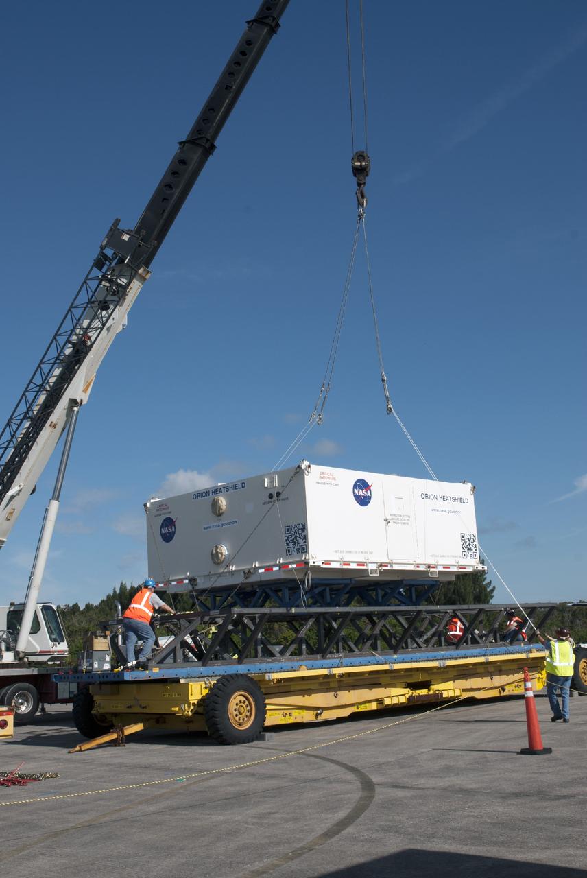 CAPE CANAVERAL, Fla. – At the Shuttle Landing Facility at NASA's Kennedy Space Center in Florida, the heat shield for the agency's Orion spacecraft has been offloaded from the Super Guppy aircraft and a crane is loading it on to a transport truck. The largest of its kind ever built, the heat shield is planned for installation on the Orion crew module in March of next year. The Orion spacecraft is scheduled to make its first unpiloted flight test, Exploration Flight Test-1 EFT-1, in September 2014.        The Orion spacecraft is designed to meet requirements for traveling beyond low-Earth orbit. The spacecraft will serve as the exploration vehicle that will carry crews to space, sustain the astronauts during the space travel and provide safe re-entry from deep space. For more information, visit: http://www.nasa.gov/orion Photo credit: NASA/Charisse Nasher