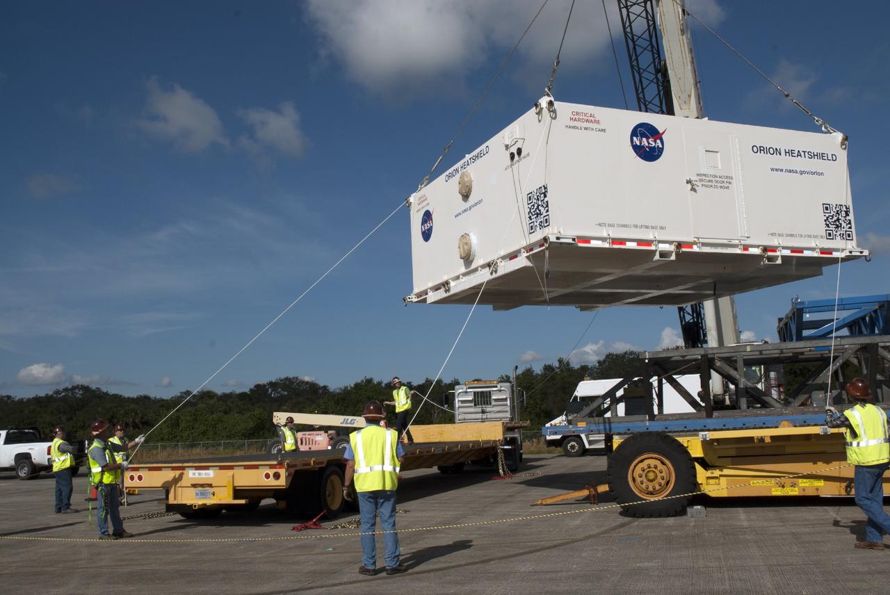 CAPE CANAVERAL, Fla. – At the Shuttle Landing Facility at NASA's Kennedy Space Center in Florida, the heat shield for the agency's Orion spacecraft has been offloaded from the Super Guppy aircraft and a crane is loading it on to a transport truck. The largest of its kind ever built, the heat shield is planned for installation on the Orion crew module in March of next year. The Orion spacecraft is scheduled to make its first unpiloted flight test, Exploration Flight Test-1 EFT-1, in September 2014.          The Orion spacecraft is designed to meet requirements for traveling beyond low-Earth orbit. The spacecraft will serve as the exploration vehicle that will carry crews to space, sustain the astronauts during the space travel and provide safe re-entry from deep space. For more information, visit: http://www.nasa.gov/orion Photo credit: NASA/Charisse Nasher