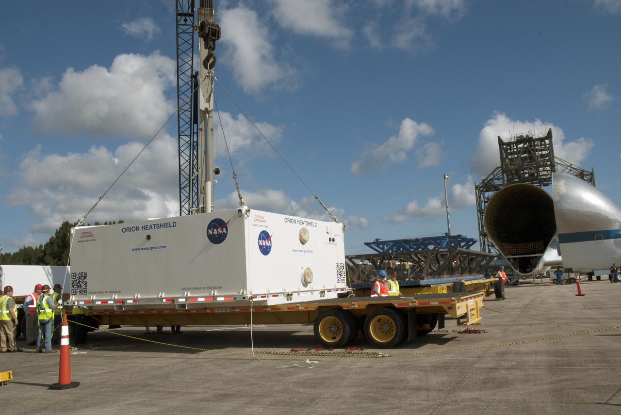 CAPE CANAVERAL, Fla. – At the Shuttle Landing Facility at NASA's Kennedy Space Center in Florida, the heat shield for the agency's Orion spacecraft has been offloaded from the Super Guppy aircraft and a crane is loading it on to a transport truck. The largest of its kind ever built, the heat shield is planned for installation on the Orion crew module in March of next year. The Orion spacecraft is scheduled to make its first unpiloted flight test, Exploration Flight Test-1 EFT-1, in September 2014.          The Orion spacecraft is designed to meet requirements for traveling beyond low-Earth orbit. The spacecraft will serve as the exploration vehicle that will carry crews to space, sustain the astronauts during the space travel and provide safe re-entry from deep space. For more information, visit: http://www.nasa.gov/orion Photo credit: NASA/Charisse Nasher