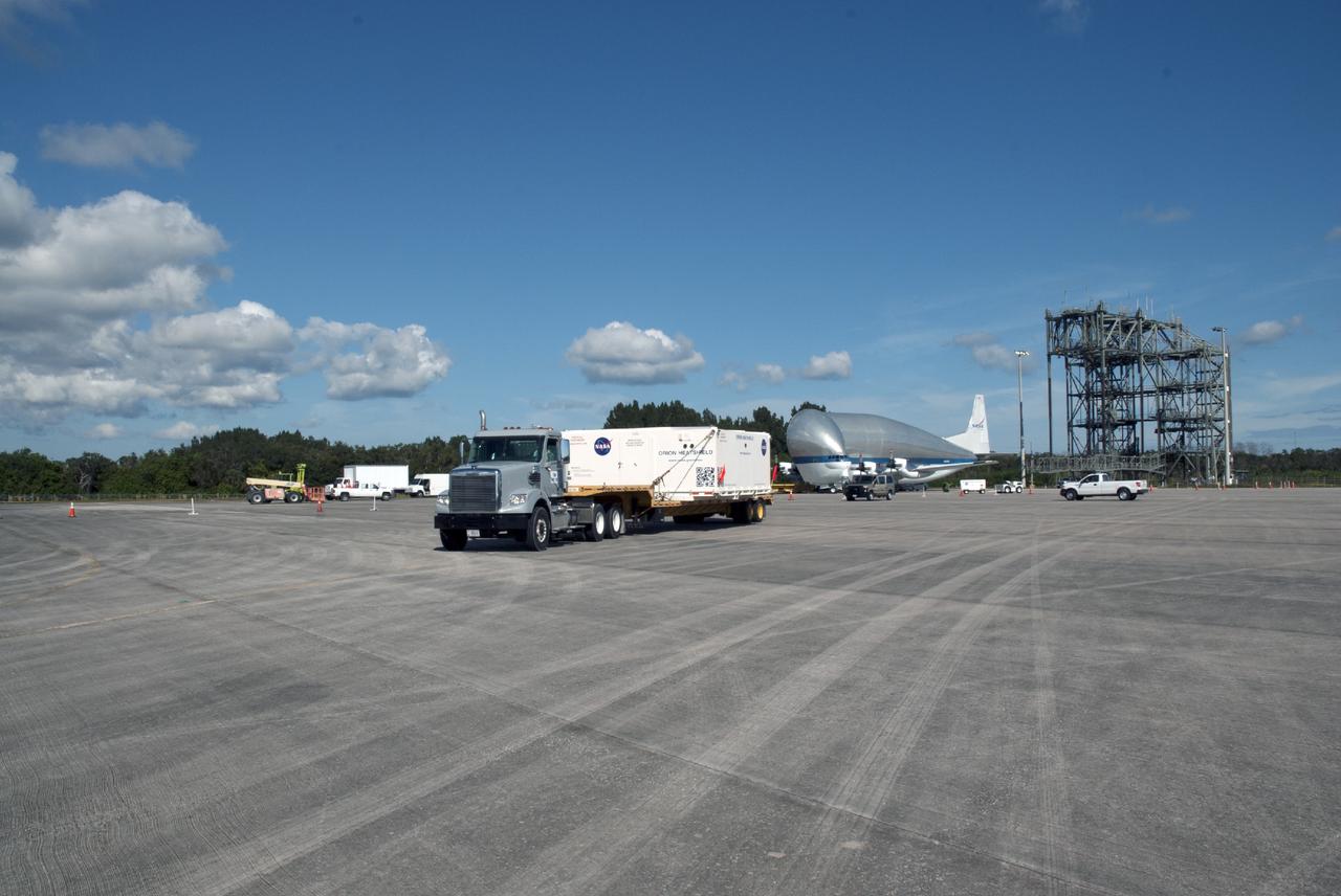 CAPE CANAVERAL, Fla. – At the Shuttle Landing Facility at NASA's Kennedy Space Center in Florida, the heat shield for the agency's Orion spacecraft has been offloaded from the Super Guppy aircraft, seen in the background. The largest of its kind ever built, the heat shield is planned for installation on the Orion crew module in March of next year. A transport truck is delivering it to Kennedy's Operations and Checkout Building where the Orion spacecraft is being prepared for its first unpiloted flight test, Exploration Flight Test-1 EFT-1, scheduled for September 2014.            The Orion spacecraft is designed to meet requirements for traveling beyond low-Earth orbit. The spacecraft will serve as the exploration vehicle that will carry crews to space, sustain the astronauts during the space travel and provide safe re-entry from deep space. For more information, visit: http://www.nasa.gov/orion Photo credit: NASA/Charisse Nasher