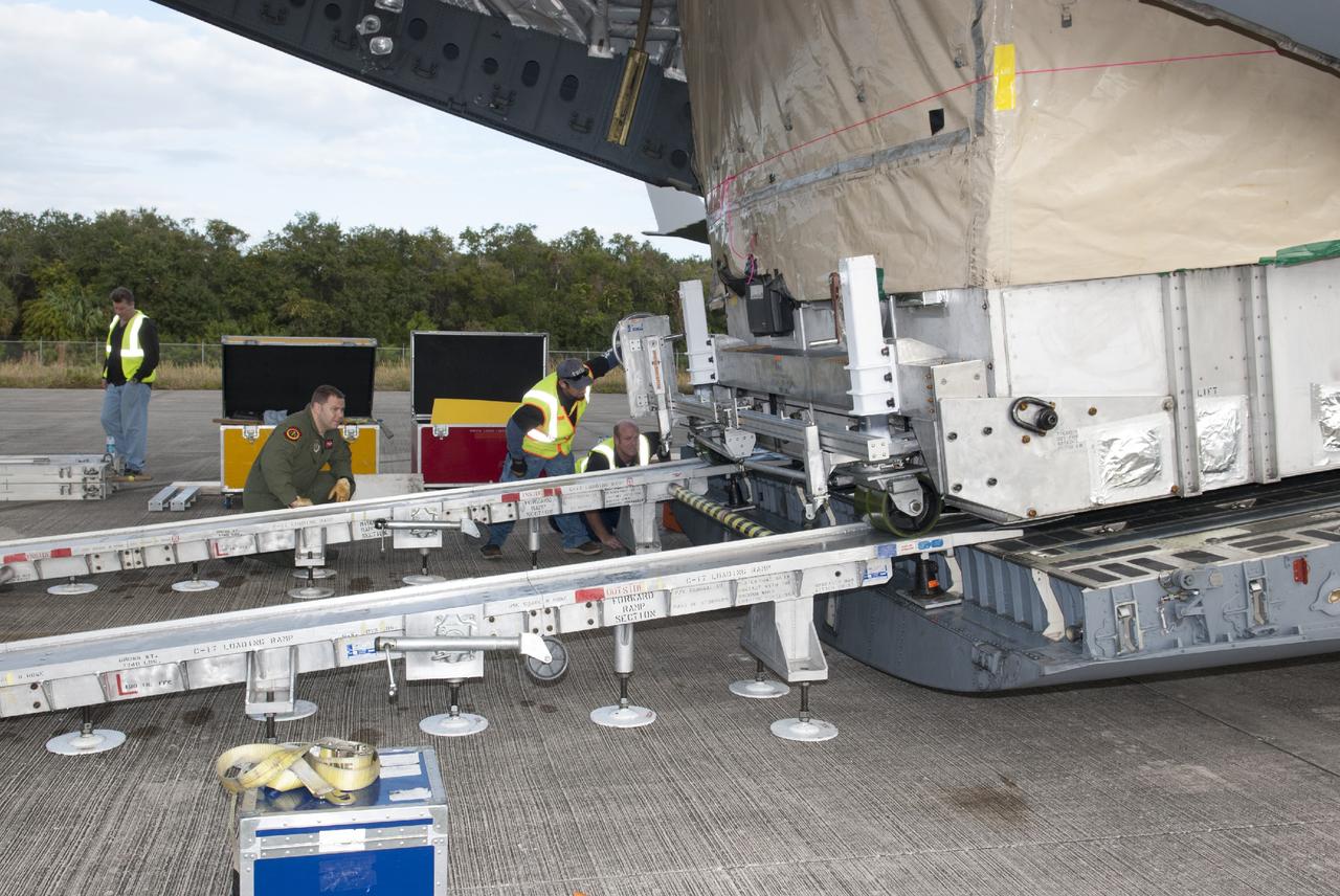 CAPE CANAVERAL, Fla. – Workers unload NASA's TDRS-L satellite from the hold of a C-17 transport aircraft at the Shuttle Landing Facility at NASA's Kennedy Space Center in Florida. The TDRS is the latest spacecraft destined for the agency's constellation of communications satellites that allows nearly continuous contact with orbiting spacecraft ranging from the International Space Station and Hubble Space Telescope to the array of scientific observatories. Photo credit: NASA/Charisse Nahser