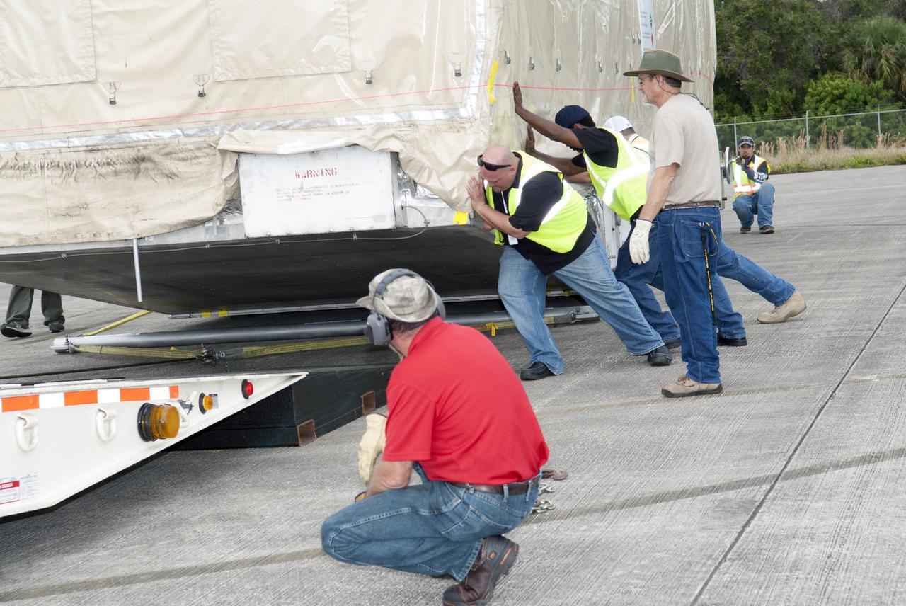 CAPE CANAVERAL, Fla. – Workers load NASA's TDRS-L satellite onto a trailer at the Shuttle Landing Facility at NASA's Kennedy Space Center in Florida. The TDRS is the latest spacecraft destined for the agency's constellation of communications satellites that allows nearly continuous contact with orbiting spacecraft ranging from the International Space Station and Hubble Space Telescope to the array of scientific observatories. Photo credit: NASA/Charisse Nahser