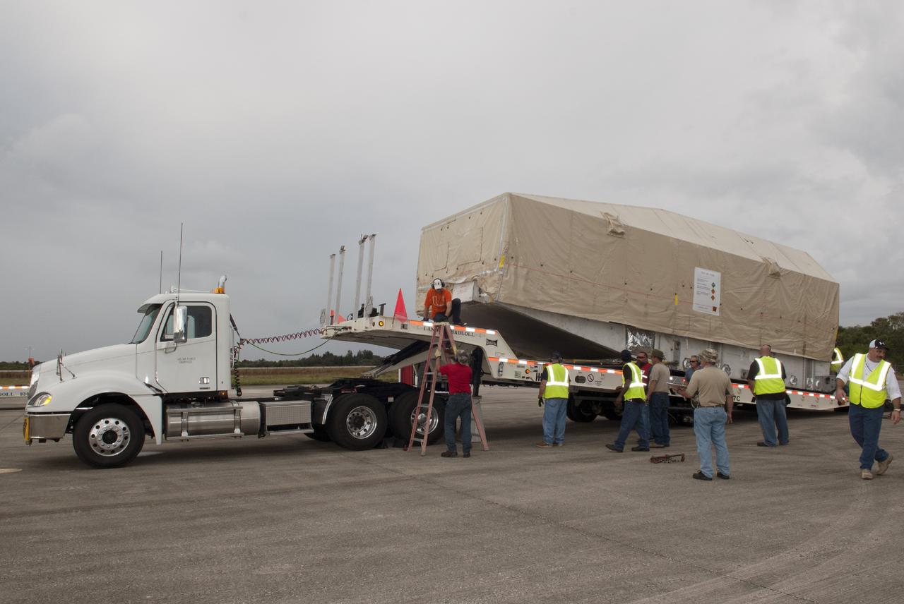 CAPE CANAVERAL, Fla. – Workers load NASA's TDRS-L satellite onto a trailer at the Shuttle Landing Facility at NASA's Kennedy Space Center in Florida. The TDRS is the latest spacecraft destined for the agency's constellation of communications satellites that allows nearly continuous contact with orbiting spacecraft ranging from the International Space Station and Hubble Space Telescope to the array of scientific observatories. Photo credit: NASA/Charisse Nahser