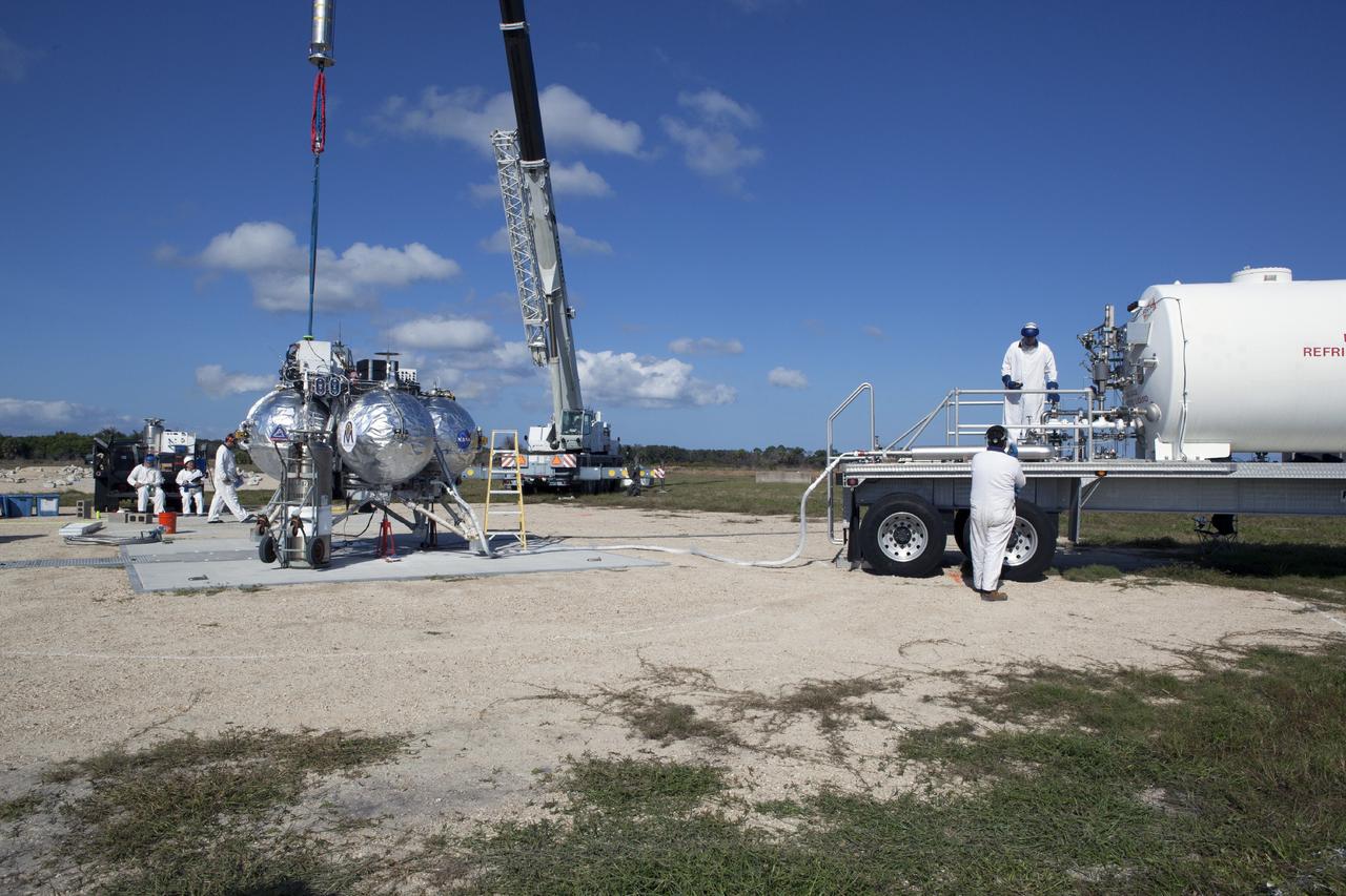 CAPE CANAVERAL, Fla. – At NASA’s Kennedy Space Center in Florida, the Project Morpheus prototype lander is being prepared for a tethered test on a transportable launch platform positioned at the north end of the Shuttle Landing Facility. The tethered test will include lifting it 20 feet by crane, ascending another 10 feet, maneuvering backwards 10 feet, and then flying forward and descending to its original position, landing at the end of the tether. Testing of the prototype lander was performed at NASA’s Johnson Space Center in Houston in preparation for tethered and free flight testing at Kennedy. The landing facility will provide the lander with the kind of field necessary for realistic testing, complete with rocks, craters and hazards to avoid. Morpheus utilizes an autonomous landing and hazard avoidance technology, or ALHAT, payload that will allow it to navigate to clear landing sites amidst rocks, craters and other hazards during its descent. Project Morpheus is being managed under the Advanced Exploration Systems, or AES, Division in NASA’s Human Exploration and Operations Mission Directorate. The efforts in AES pioneer new approaches for rapidly developing prototype systems, demonstrating key capabilities and validating operational concepts for future human missions beyond Earth orbit. For more information on Project Morpheus, visit http://morpheuslander.jsc.nasa.gov. Photo credit: NASA/Daniel Casper