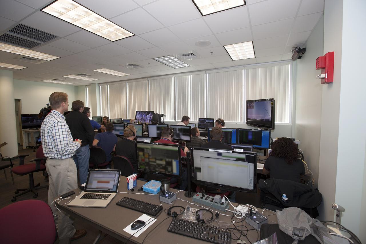 CAPE CANAVERAL, Fla. – Inside a control room at NASA’s Kennedy Space Center in Florida, engineers monitor the progress as the Project Morpheus prototype lander is being prepared for a tether test on a transportable launch platform positioned at the north end of the Shuttle Landing Facility. The tethered test will include lifting it 20 feet by crane, ascending another 10 feet, maneuvering backwards 10 feet, and then flying forward and descending to its original position, landing at the end of the tether. Testing of the prototype lander was performed at NASA’s Johnson Space Center in Houston in preparation for tethered and free flight testing at Kennedy. The landing facility will provide the lander with the kind of field necessary for realistic testing, complete with rocks, craters and hazards to avoid. Morpheus utilizes an autonomous landing and hazard avoidance technology, or ALHAT, payload that will allow it to navigate to clear landing sites amidst rocks, craters and other hazards during its descent. Project Morpheus is being managed under the Advanced Exploration Systems, or AES, Division in NASA’s Human Exploration and Operations Mission Directorate. The efforts in AES pioneer new approaches for rapidly developing prototype systems, demonstrating key capabilities and validating operational concepts for future human missions beyond Earth orbit. For more information on Project Morpheus, visit http://morpheuslander.jsc.nasa.gov. Photo credit: NASA/Daniel Casper
