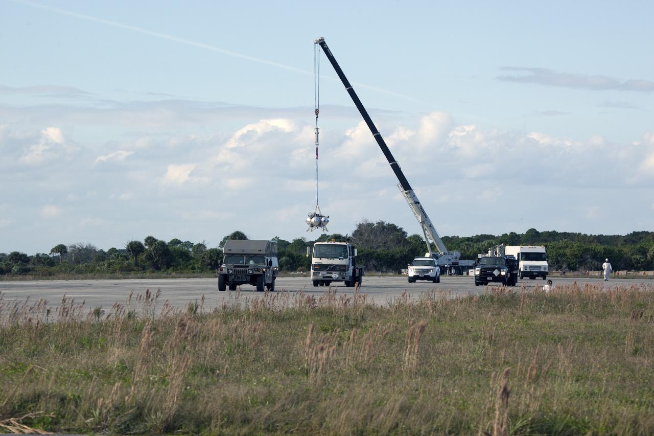 CAPE CANAVERAL, Fla. – At NASA’s Kennedy Space Center in Florida, the Project Morpheus prototype lander has been attached to a tether and is being raised from a transportable launch platform positioned at the north end of the Shuttle Landing Facility. The tethered test includes lifting the lander 20 feet by crane, ascending another 10 feet, maneuvering backwards 10 feet, and then flying forward and descending to its original position, landing at the end of the tether. Testing of the prototype lander was performed at NASA’s Johnson Space Center in Houston in preparation for tethered and free flight testing at Kennedy. The landing facility will provide the lander with the kind of field necessary for realistic testing, complete with rocks, craters and hazards to avoid. Morpheus utilizes an autonomous landing and hazard avoidance technology, or ALHAT, payload that will allow it to navigate to clear landing sites amidst rocks, craters and other hazards during its descent. Project Morpheus is being managed under the Advanced Exploration Systems, or AES, Division in NASA’s Human Exploration and Operations Mission Directorate. The efforts in AES pioneer new approaches for rapidly developing prototype systems, demonstrating key capabilities and validating operational concepts for future human missions beyond Earth orbit. For more information on Project Morpheus, visit http://morpheuslander.jsc.nasa.gov. Photo credit: NASA/Daniel Casper