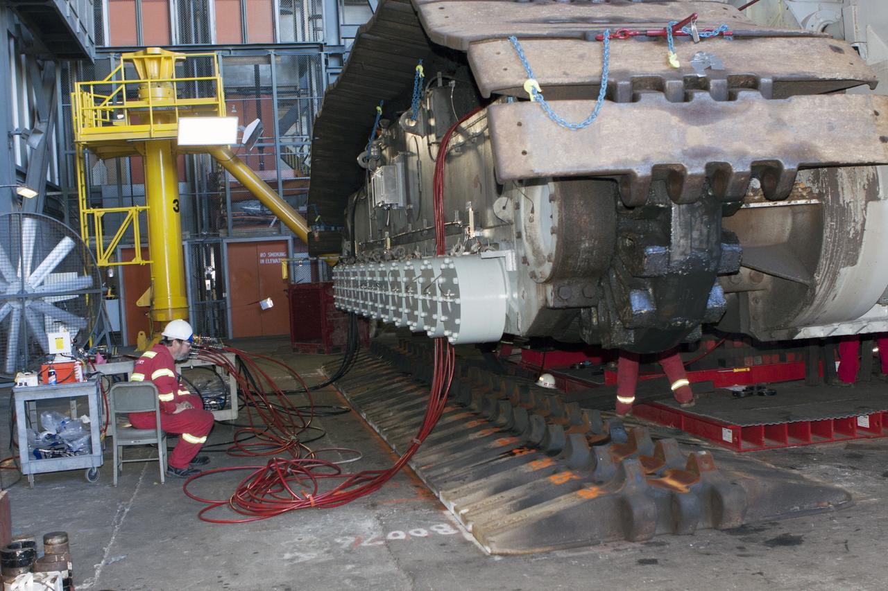 CAPE CANAVERAL, Fla. – Inside the Vehicle Assembly Building at NASA’s Kennedy Space Center in Florida, preparations are underway to lower crawler-transporter 2, or CT-2, from jack stands so that work can begin to re-install the large crawler tracks. The crawler is being prepared for rollout in January 2014 to test the new bearings that were recently installed.    Work continues in high bay 2 to upgrade CT-2. The modifications are designed to ensure CT-2’s ability to transport launch vehicles currently in development, such as the agency’s Space Launch System, to the launch pad. The Ground Systems Development and Operations Program office at Kennedy is overseeing the upgrades. For more than 45 years the crawler-transporters were used to transport the mobile launcher platform and the Apollo-Saturn V rockets and, later, space shuttles to Launch Pads 39A and B. For more information, visit: http://www.nasa.gov/centers/kennedy/pdf/638823main_crawler-transporter.pdf. Photo credit: NASA/Jim Grossmann