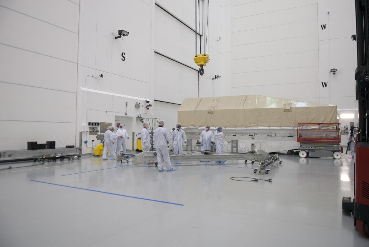 CAPE CANAVERAL, Fla. – Engineers prepare to uncrate NASA's TDRS-L satellite inside the Astrotech payload processing facility in Titusville for launch processing. The TDRS is the latest spacecraft destined for the agency's constellation of communications satellites that allows nearly continuous contact with orbiting spacecraft ranging from the International Space Station and Hubble Space Telescope to the array of scientific observatories. Photo credit: NASA/Tim Jacobs