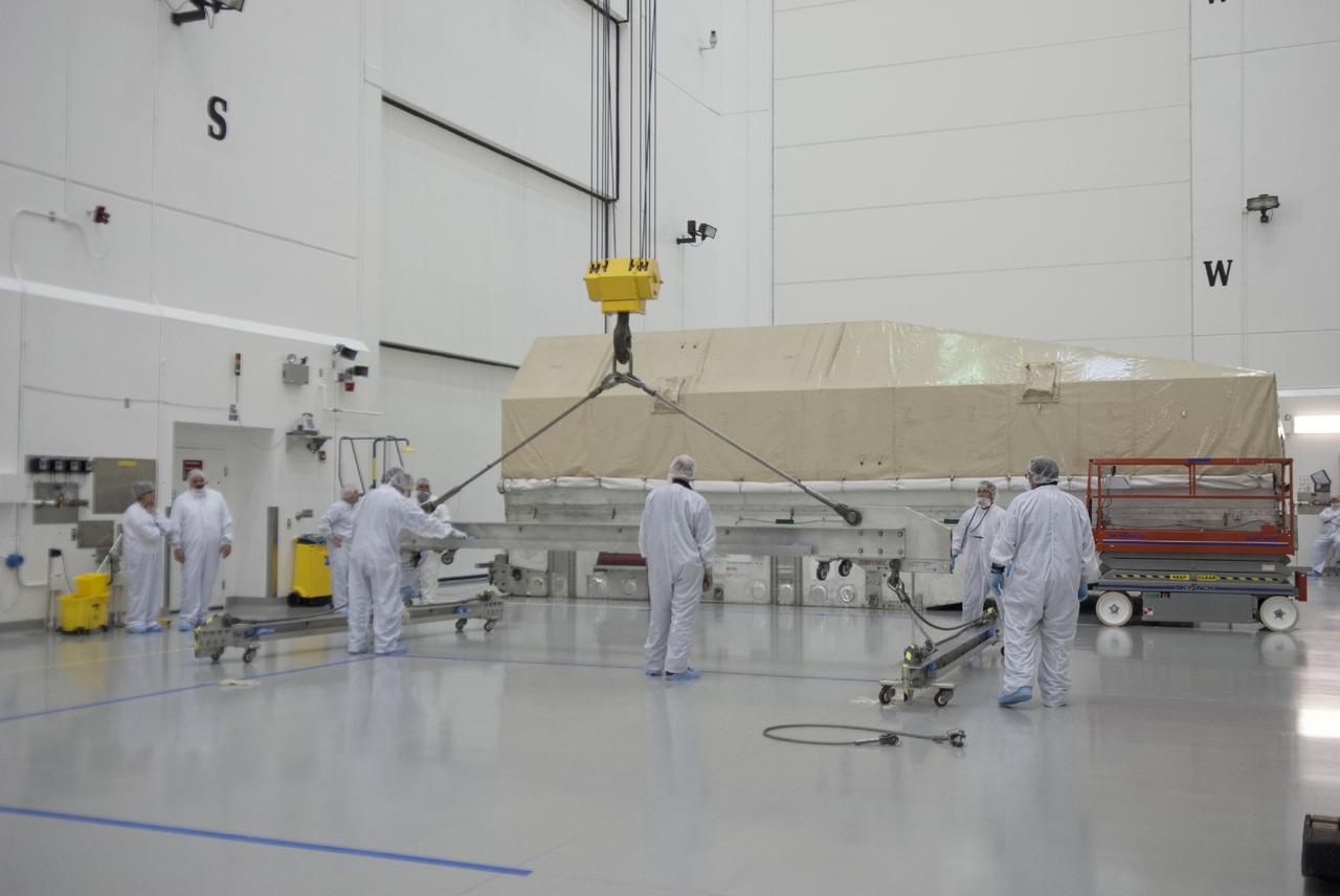 CAPE CANAVERAL, Fla. – Engineers prepare to uncrate NASA's TDRS-L satellite inside the Astrotech payload processing facility in Titusville for launch processing. The TDRS is the latest spacecraft destined for the agency's constellation of communications satellites that allows nearly continuous contact with orbiting spacecraft ranging from the International Space Station and Hubble Space Telescope to the array of scientific observatories. Photo credit: NASA/Tim Jacobs