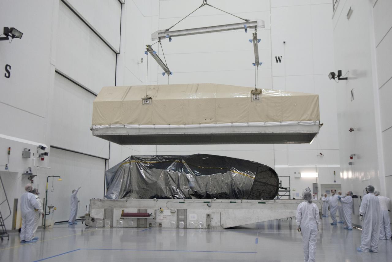 CAPE CANAVERAL, Fla. – Engineers lift the top off a shipping container to reveal NASA's TDRS-L satellite inside the high bay at the Astrotech payload processing facility in Titusville for launch processing. The TDRS is the latest spacecraft destined for the agency's constellation of communications satellites that allows nearly continuous contact with orbiting spacecraft ranging from the International Space Station and Hubble Space Telescope to the array of scientific observatories. Photo credit: NASA/Tim Jacobs