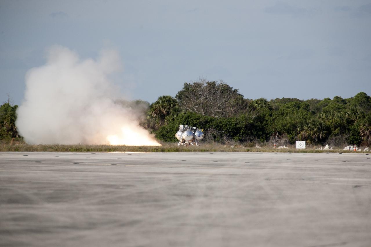 CAPE CANAVERAL, Fla. – The first free flight of the Project Morpheus prototype lander begins as the lander’s engine fires at the north of the Shuttle Landing Facility at NASA’s Kennedy Space Center in Florida. Testing of the prototype lander was performed at NASA’s Johnson Space Center in Houston in preparation for tethered and free flight testing at Kennedy. Project Morpheus integrates NASA’s automated landing and hazard avoidance technology, or ALHAT, with an engine that runs on liquid oxygen and methane, or green propellants, into a fully-operational lander that could deliver cargo to asteroids and other planetary surfaces.    The landing facility will provide the lander with the kind of field necessary for realistic testing, complete with rocks, craters and hazards to avoid. Morpheus’ ALHAT payload allows it to navigate to clear landing sites amidst rocks, craters and other hazards during its descent. Project Morpheus is being managed under the Advanced Exploration Systems, or AES, Division in NASA’s Human Exploration and Operations Mission Directorate. The efforts in AES pioneer new approaches for rapidly developing prototype systems, demonstrating key capabilities and validating operational concepts for future human missions beyond Earth orbit. For more information on Project Morpheus, visit http://morpheuslander.jsc.nasa.gov.  Photo credit: NASA/Kim Shiflett