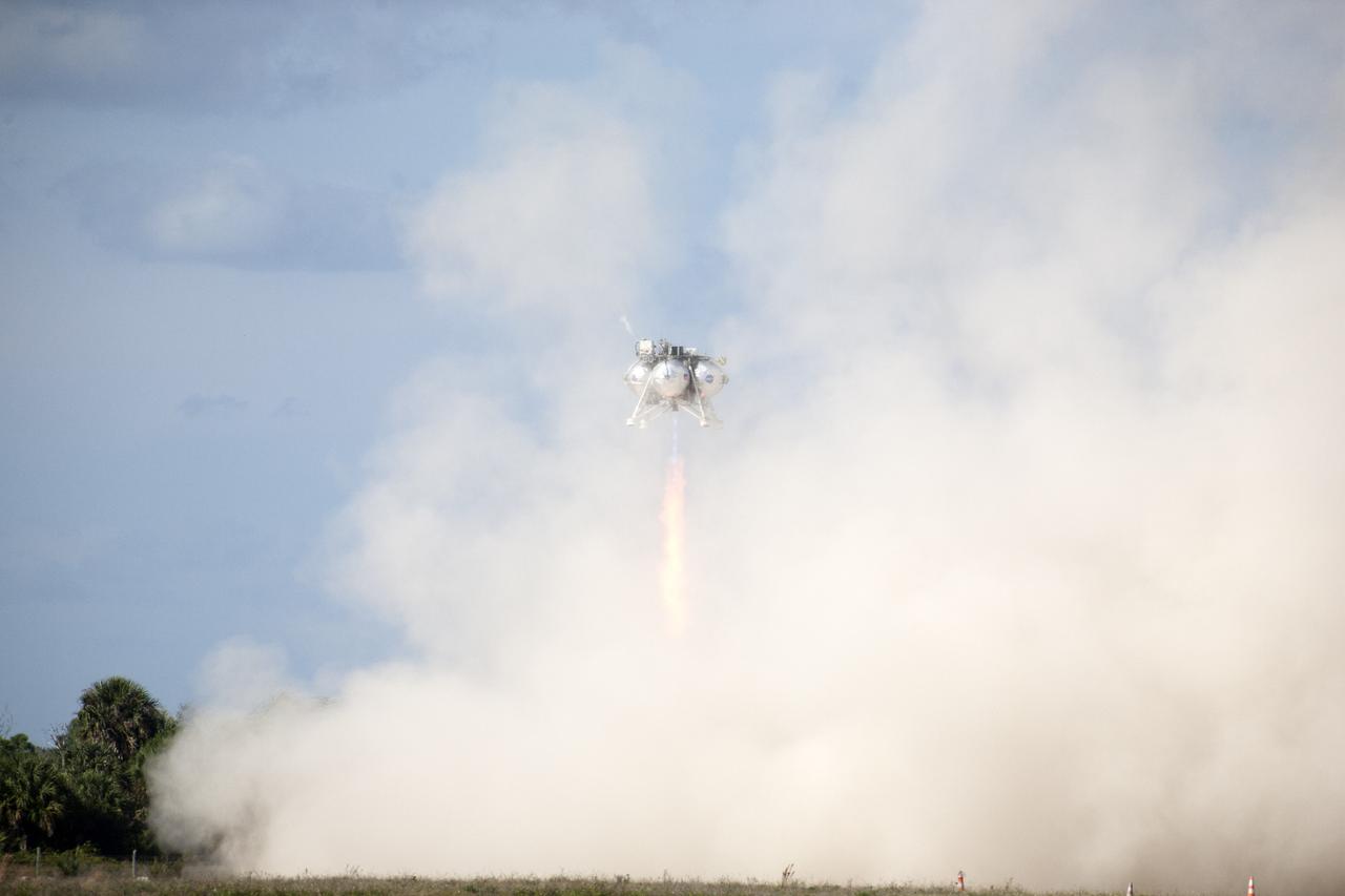 CAPE CANAVERAL, Fla. – The first free flight of the Project Morpheus prototype lander was conducted at the Shuttle Landing Facility at NASA’s Kennedy Space Center in Florida. Smoke fills the air as the engine fires and the Morpheus lander launched from the ground over a flame trench. During the 54-second test, it ascended approximately 50 feet, and hovered for about 15 seconds. The lander then flew forward and landed on its pad about 23 feet from the launch point. Testing of the prototype lander was performed at NASA’s Johnson Space Center in Houston in preparation for tethered and free flight testing at Kennedy. Project Morpheus integrates NASA’s automated landing and hazard avoidance technology, or ALHAT, with an engine that runs on liquid oxygen and methane, or green propellants, into a fully-operational lander that could deliver cargo to asteroids and other planetary surfaces.    The landing facility will provide the lander with the kind of field necessary for realistic testing, complete with rocks, craters and hazards to avoid. Morpheus’ ALHAT payload allows it to navigate to clear landing sites amidst rocks, craters and other hazards during its descent. Project Morpheus is being managed under the Advanced Exploration Systems, or AES, Division in NASA’s Human Exploration and Operations Mission Directorate. The efforts in AES pioneer new approaches for rapidly developing prototype systems, demonstrating key capabilities and validating operational concepts for future human missions beyond Earth orbit. For more information on Project Morpheus, visit http://morpheuslander.jsc.nasa.gov.  Photo credit: NASA/Kim Shiflett