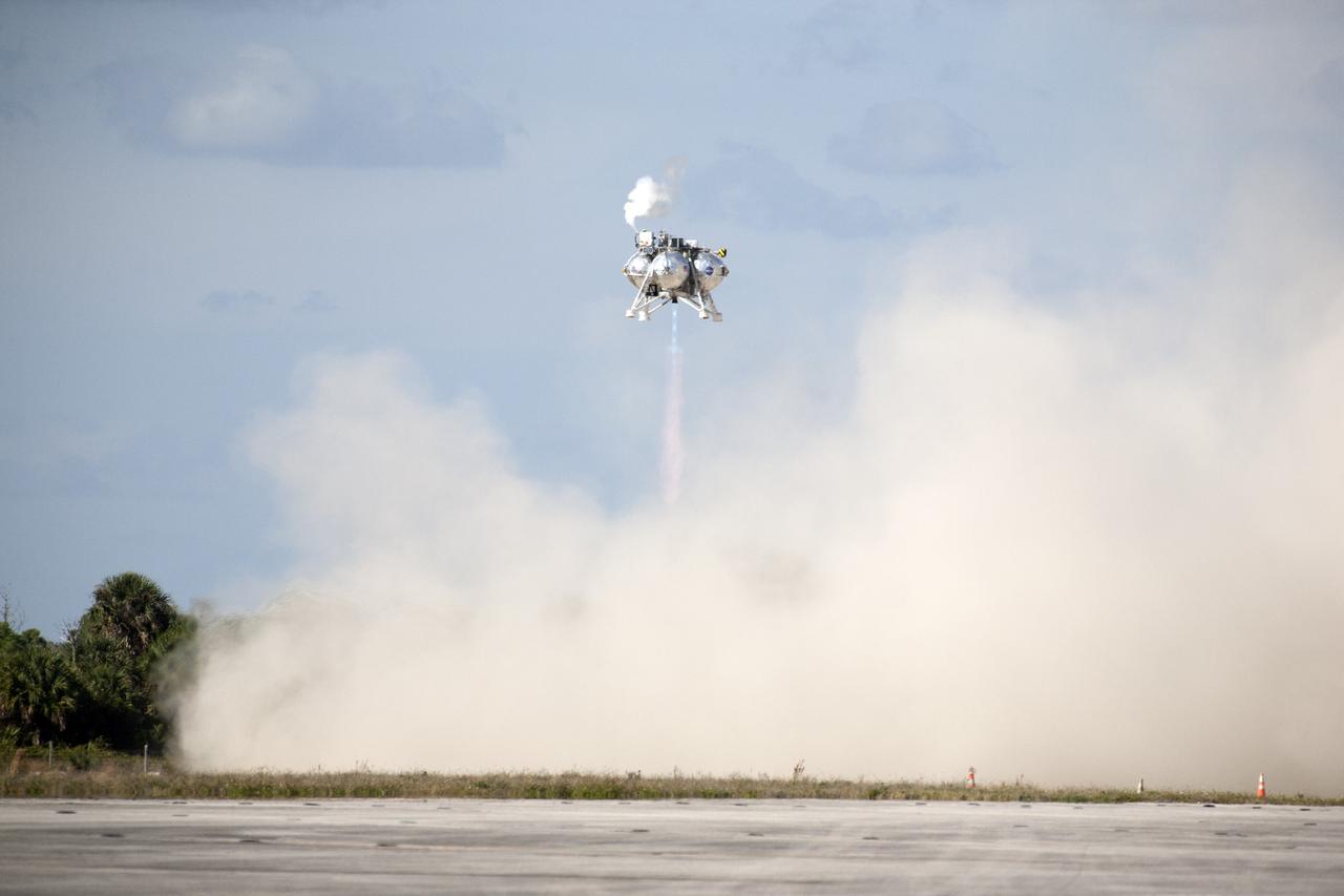 CAPE CANAVERAL, Fla. – The first free flight of the Project Morpheus prototype lander was conducted at the Shuttle Landing Facility at NASA’s Kennedy Space Center in Florida. Smoke fills the air as the engine fires and the Morpheus lander launched from the ground over a flame trench. During the 54-second test, it ascended approximately 50 feet, and hovered for about 15 seconds. The lander then flew forward and landed on its pad about 23 feet from the launch point. Testing of the prototype lander was performed at NASA’s Johnson Space Center in Houston in preparation for tethered and free flight testing at Kennedy. Project Morpheus integrates NASA’s automated landing and hazard avoidance technology, or ALHAT, with an engine that runs on liquid oxygen and methane, or green propellants, into a fully-operational lander that could deliver cargo to asteroids and other planetary surfaces.    The landing facility will provide the lander with the kind of field necessary for realistic testing, complete with rocks, craters and hazards to avoid. Morpheus’ ALHAT payload allows it to navigate to clear landing sites amidst rocks, craters and other hazards during its descent. Project Morpheus is being managed under the Advanced Exploration Systems, or AES, Division in NASA’s Human Exploration and Operations Mission Directorate. The efforts in AES pioneer new approaches for rapidly developing prototype systems, demonstrating key capabilities and validating operational concepts for future human missions beyond Earth orbit. For more information on Project Morpheus, visit http://morpheuslander.jsc.nasa.gov.  Photo credit: NASA/Kim Shiflett