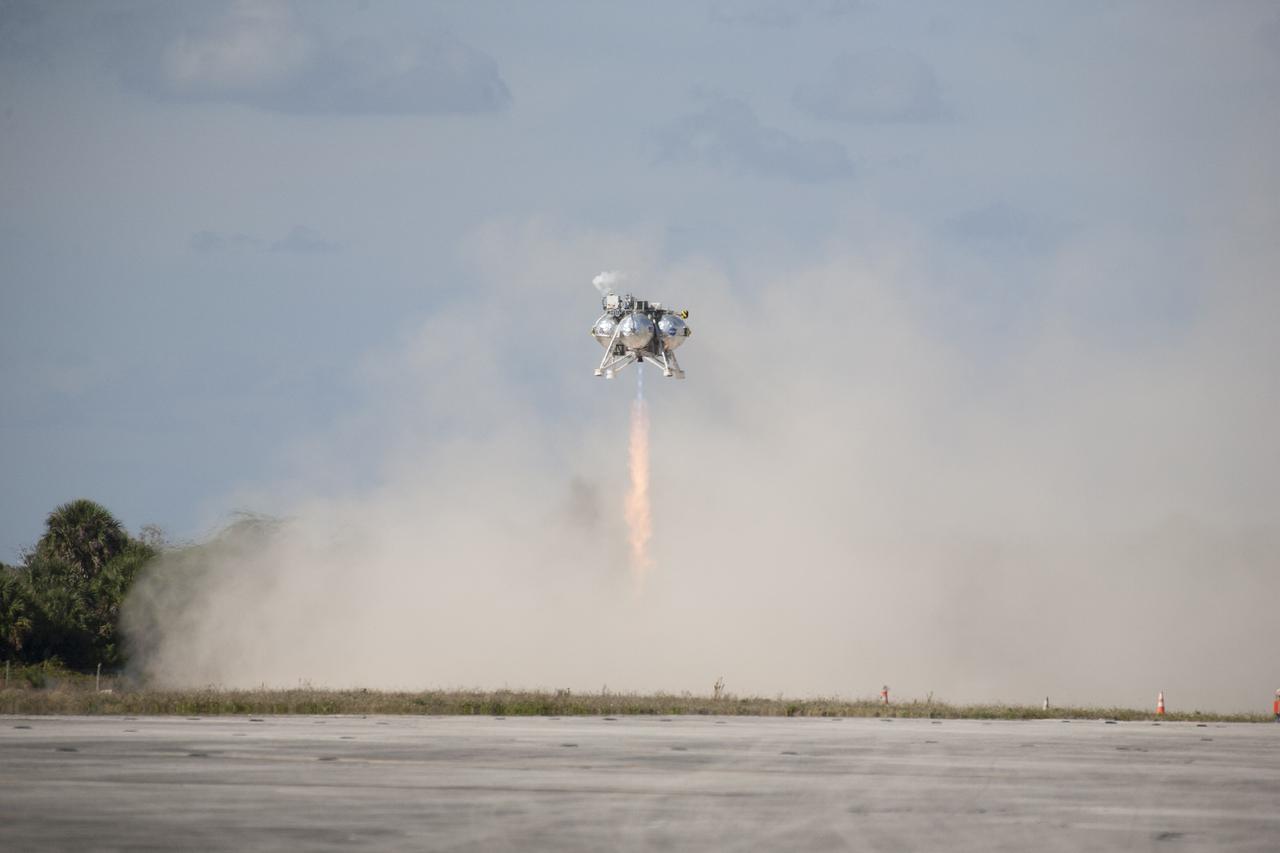 CAPE CANAVERAL, Fla. – The first free flight of the Project Morpheus prototype lander was conducted at the Shuttle Landing Facility at NASA’s Kennedy Space Center in Florida. Smoke fills the air as the engine fires and the Morpheus lander launched from the ground over a flame trench. During the 54-second test, it ascended approximately 50 feet, and hovered for about 15 seconds. The lander then flew forward and landed on its pad about 23 feet from the launch point. Testing of the prototype lander was performed at NASA’s Johnson Space Center in Houston in preparation for tethered and free flight testing at Kennedy. Project Morpheus integrates NASA’s automated landing and hazard avoidance technology, or ALHAT, with an engine that runs on liquid oxygen and methane, or green propellants, into a fully-operational lander that could deliver cargo to asteroids and other planetary surfaces.    The landing facility will provide the lander with the kind of field necessary for realistic testing, complete with rocks, craters and hazards to avoid. Morpheus’ ALHAT payload allows it to navigate to clear landing sites amidst rocks, craters and other hazards during its descent. Project Morpheus is being managed under the Advanced Exploration Systems, or AES, Division in NASA’s Human Exploration and Operations Mission Directorate. The efforts in AES pioneer new approaches for rapidly developing prototype systems, demonstrating key capabilities and validating operational concepts for future human missions beyond Earth orbit. For more information on Project Morpheus, visit http://morpheuslander.jsc.nasa.gov.  Photo credit: NASA/Kim Shiflett