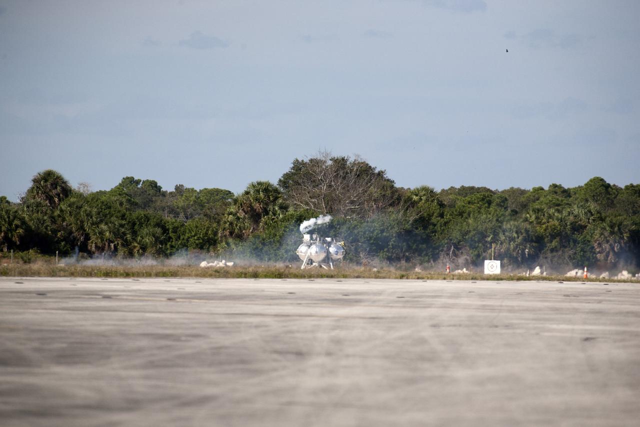 CAPE CANAVERAL, Fla. – The first free flight of the Project Morpheus prototype lander was conducted at the Shuttle Landing Facility at NASA’s Kennedy Space Center in Florida. The engine fired and the Morpheus lander launched from the ground over a flame trench. During the 54-second test, it ascended approximately 50 feet, and hovered for about 15 seconds. The lander then flew forward and landed on its pad about 23 feet from the launch point. Testing of the prototype lander was performed at NASA’s Johnson Space Center in Houston in preparation for tethered and free flight testing at Kennedy. Project Morpheus integrates NASA’s automated landing and hazard avoidance technology, or ALHAT, with an engine that runs on liquid oxygen and methane, or green propellants, into a fully-operational lander that could deliver cargo to asteroids and other planetary surfaces.      The landing facility will provide the lander with the kind of field necessary for realistic testing, complete with rocks, craters and hazards to avoid. Morpheus’ ALHAT payload allows it to navigate to clear landing sites amidst rocks, craters and other hazards during its descent. Project Morpheus is being managed under the Advanced Exploration Systems, or AES, Division in NASA’s Human Exploration and Operations Mission Directorate. The efforts in AES pioneer new approaches for rapidly developing prototype systems, demonstrating key capabilities and validating operational concepts for future human missions beyond Earth orbit. For more information on Project Morpheus, visit http://morpheuslander.jsc.nasa.gov.  Photo credit: NASA/Kim Shiflett