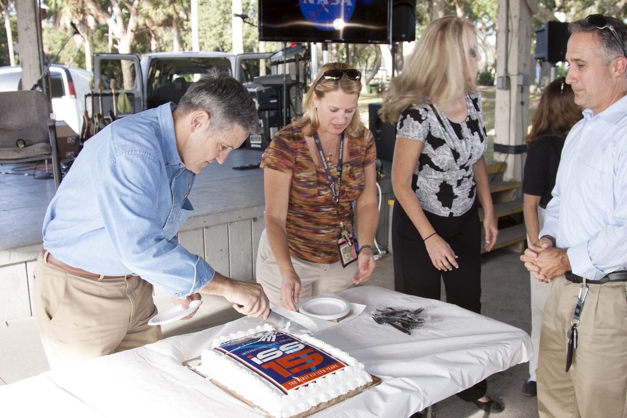 CAPE CANAVERAL, Fla. – At NASA's Kennedy Space Center in Florida, the center's director, Bob Cabana, cuts a 15th anniversary cake during an employee celebration commemorating the start of assembly of the International Space Station. Cabana served as commander of STS-88, the space shuttle mission that launched the first American-built element of the space station, beginning the effort to construct the orbiting complex. Also participating in the ceremony were STS-88 mission specialists Nancy Currie and Jerry Ross. The Russian Space Agency's Functional Cargo Block, named "Zarya," was launched from the Baikonur Cosmodrome in Kazakhstan on Nov. 20, 1998. Two weeks later, on Dec. 4, 1998, the space shuttle Endeavour lifted off from Kennedy on STS-88 with node 1, called "Unity." In addition to Cabana, Curie and Ross, the crew also included pilot Rick Sturckow, along with mission specialists Jim Newman and Sergei Krikalev, a Russian cosmonaut. For more information, visit: http://www.nasa.gov/mission_pages/station/main/index.html Photo credit: NASA/Jim Grossman