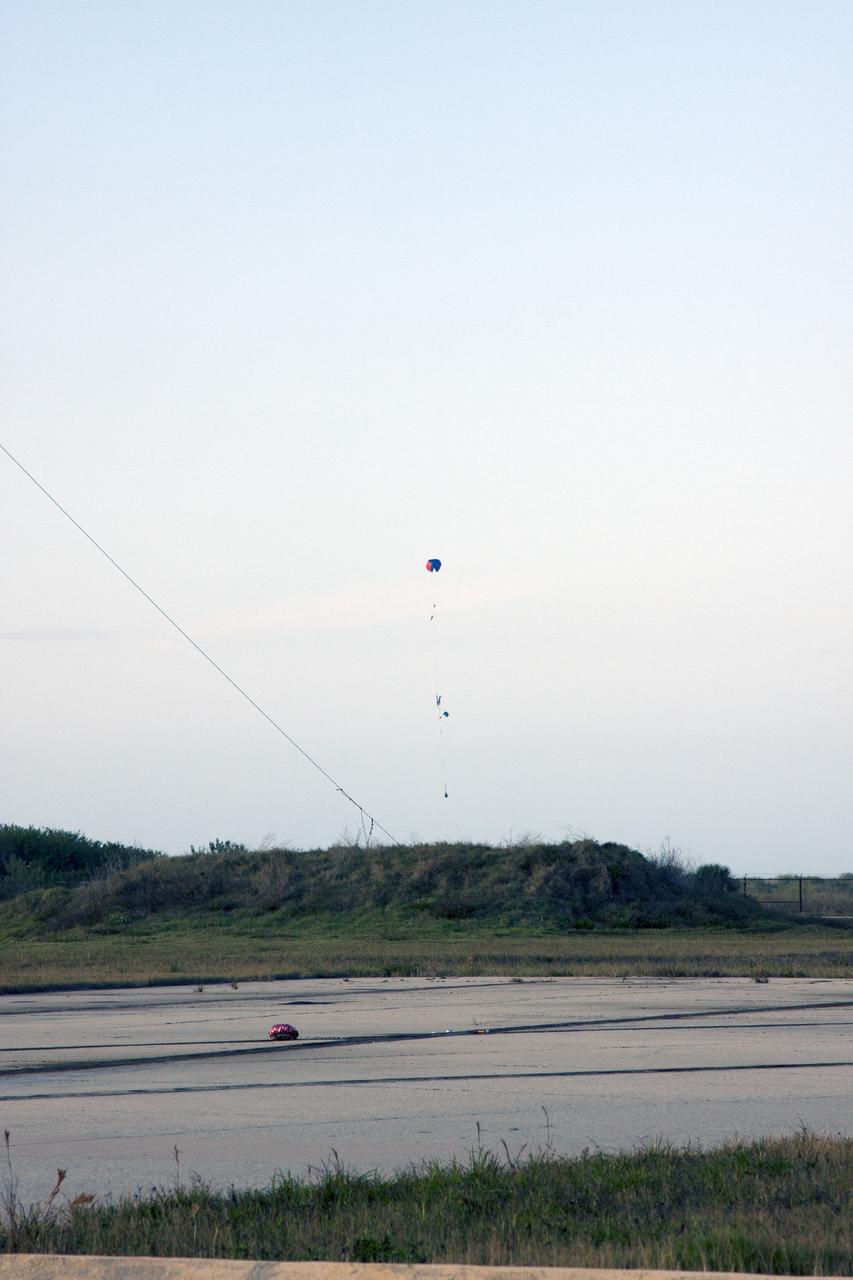 CAPE CANAVERAL, Fla. -- At NASA's Kennedy Space Center in Florida, a small rocket descends on a parachute as part of Rocket University. The launch tested systems designed by the student engineers.      As part of Rocket University, the engineers are given an opportunity to work a fast-track project to develop skills in developing spacecraft systems of the future. As NASA plans for future spaceflight programs to low-Earth orbit and beyond, teams of engineers at Kennedy are gaining experience in designing and flying launch vehicle systems on a small scale. Four teams of five to eight members from Kennedy are designing rockets complete with avionics and recovery systems. Launch operations require coordination with federal agencies, just as they would with rockets launched in support of a NASA mission. Photo credit: NASA/Jim Grossmann