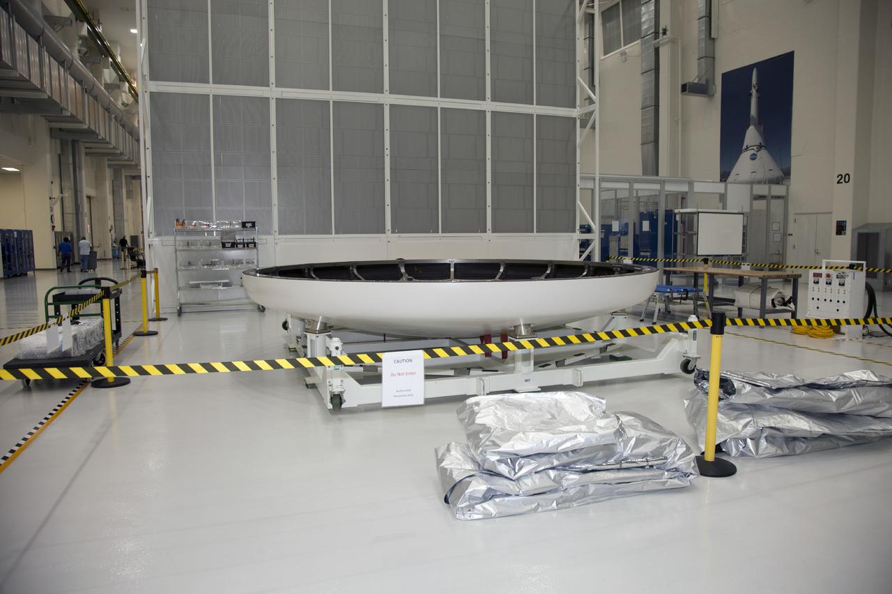 CAPE CANAVERAL, Fla. -- The heat shield for the Orion spacecraft has been placed on a work stand inside the Operations and Checkout Building high bay at NASA’s Kennedy Space Center in Florida. The heat shield arrived at Kennedy’s Shuttle Landing Facility on Dec. 5 on NASA’s Super Guppy aircraft. The largest of its kind ever built, the heat shield is planned for installation on the Orion crew module in March 2014.    The Orion spacecraft is being prepared for its first unpiloted flight test, Exploration Flight Test-1, or EFT-1, scheduled for launch atop a Delta IV rocket in September 2014. The Orion spacecraft is designed to carry astronauts to destinations not yet explored by humans. It will have emergency abort capability, sustain the crew during space travel and provide safe re-entry from deep space return velocities. Orion is scheduled to launch atop NASA’s Space Launch System rocket in 2017. For more information, visit http://www.nasa.gov/orion. Photo credit: NASA/Mike Chambers